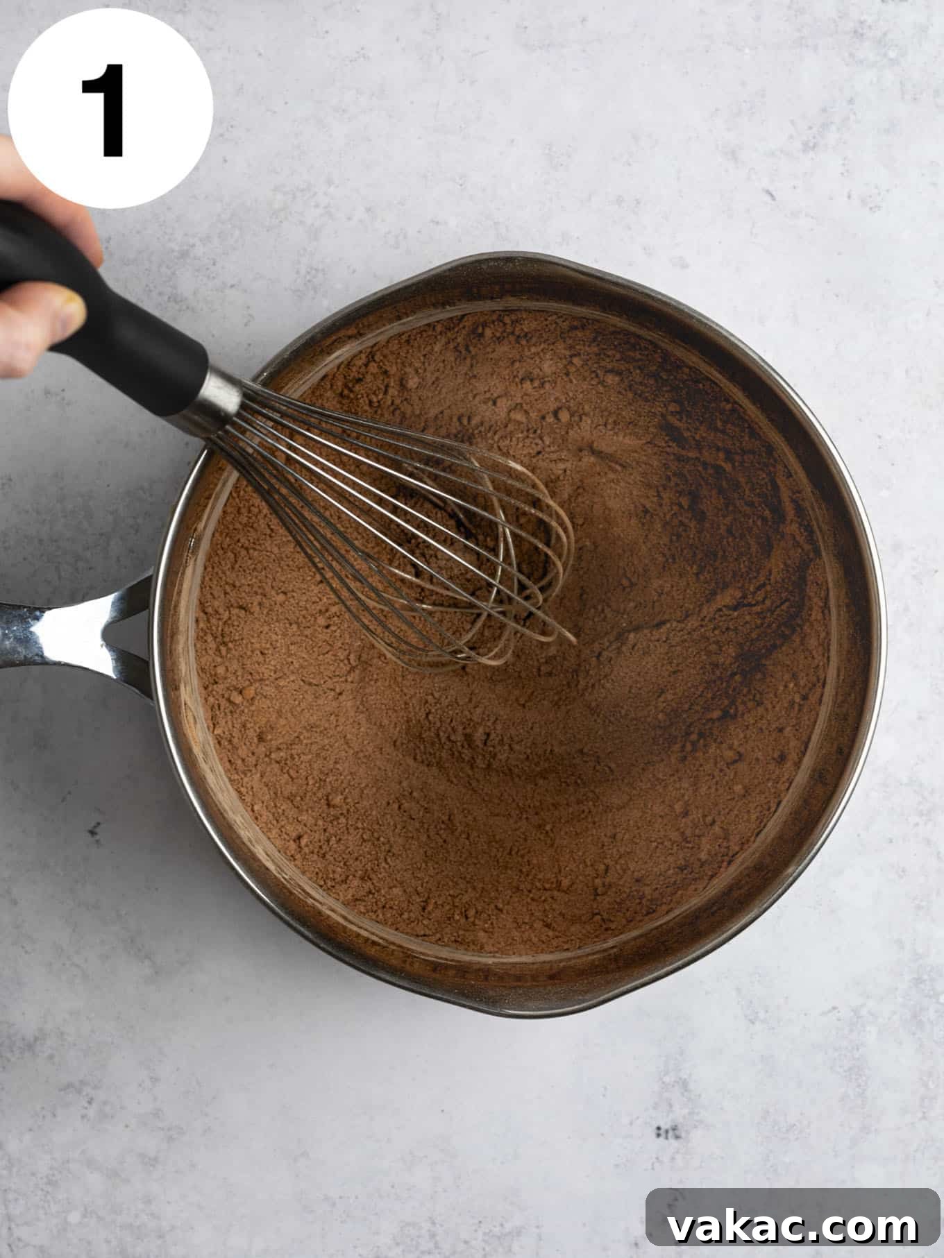 Silky Chocolate Indulgence 4 An overhead view of a cocoa powder mixture in a metal saucepan.