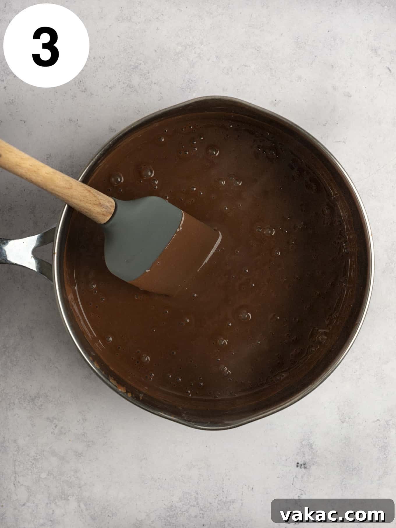 Silky Chocolate Indulgence 6 An overhead view of the boiling mixture in a metal saucepan.
