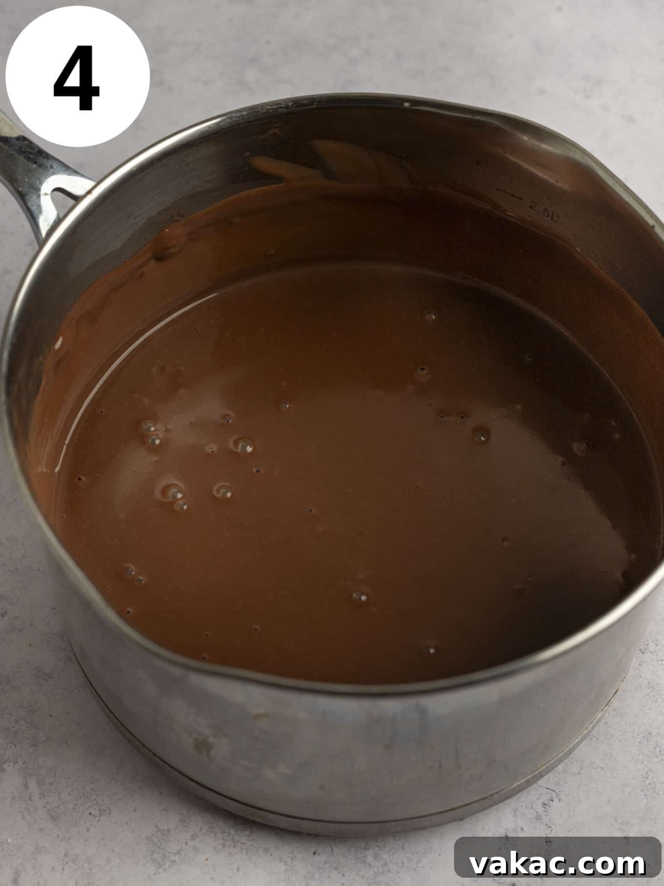 Silky Chocolate Indulgence 7 An overhead view of a chocolate pudding in a metal saucepan.