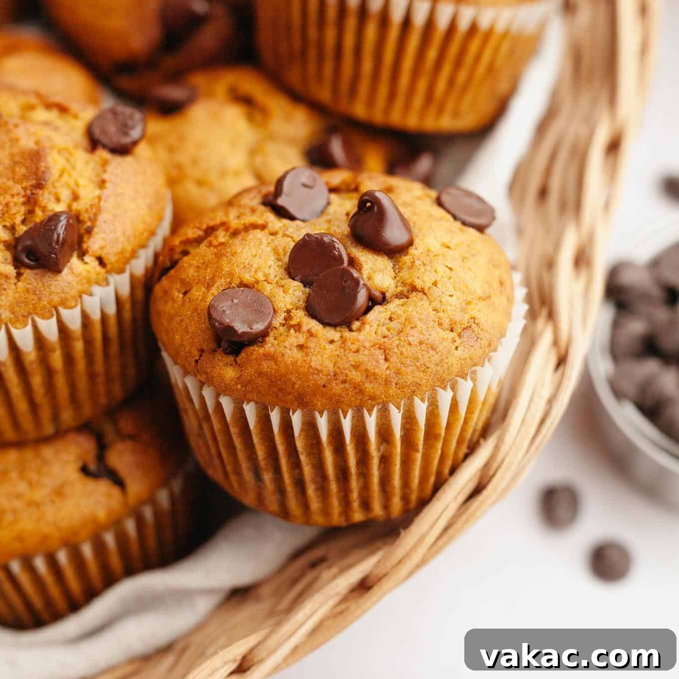 Harvest Pumpkin Chocolate Chip Muffins 10 Several pumpkin chocolate chip muffins in a basket.