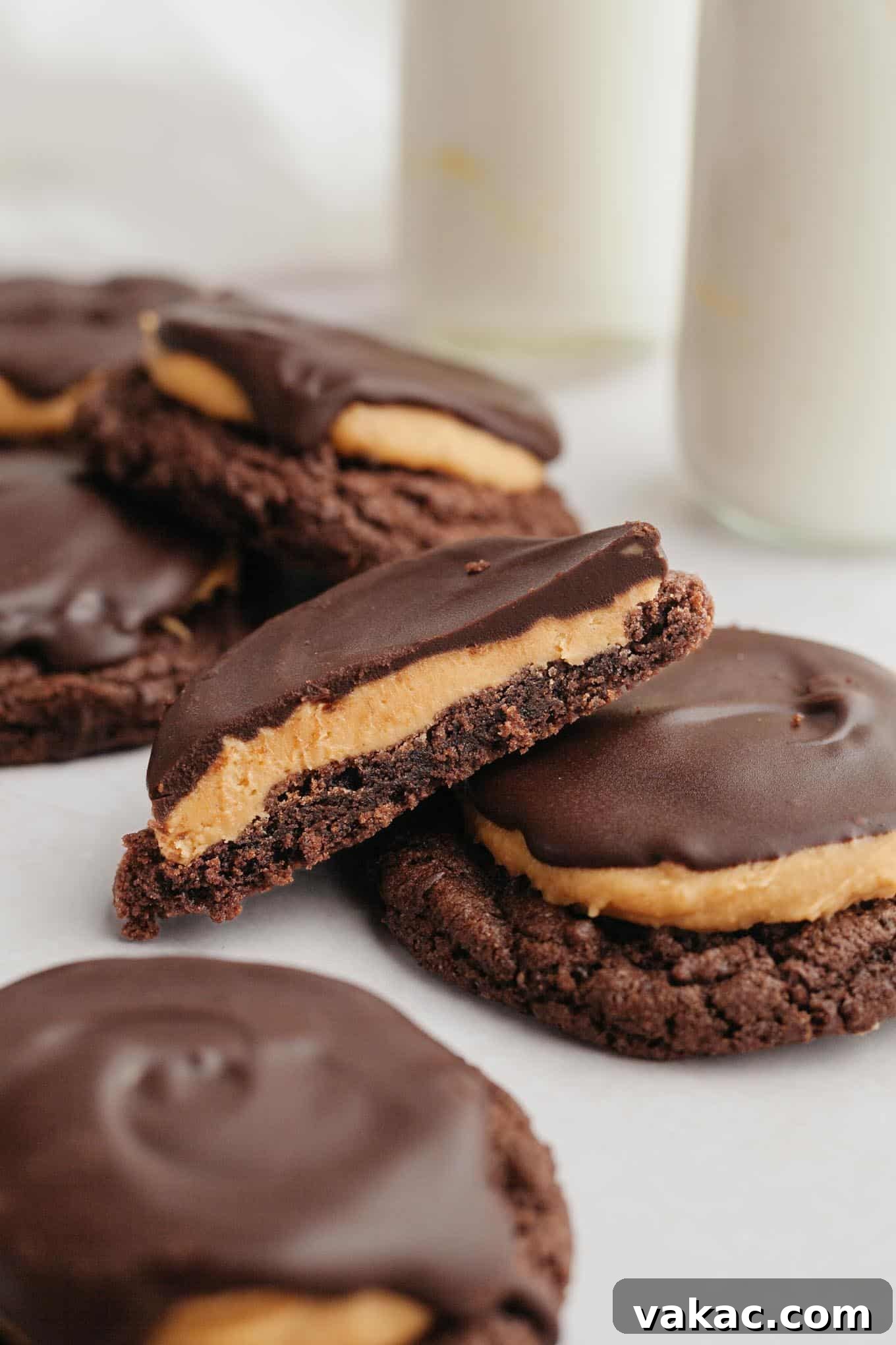 Half of a Buckeye cookie angled on top of another cookie.