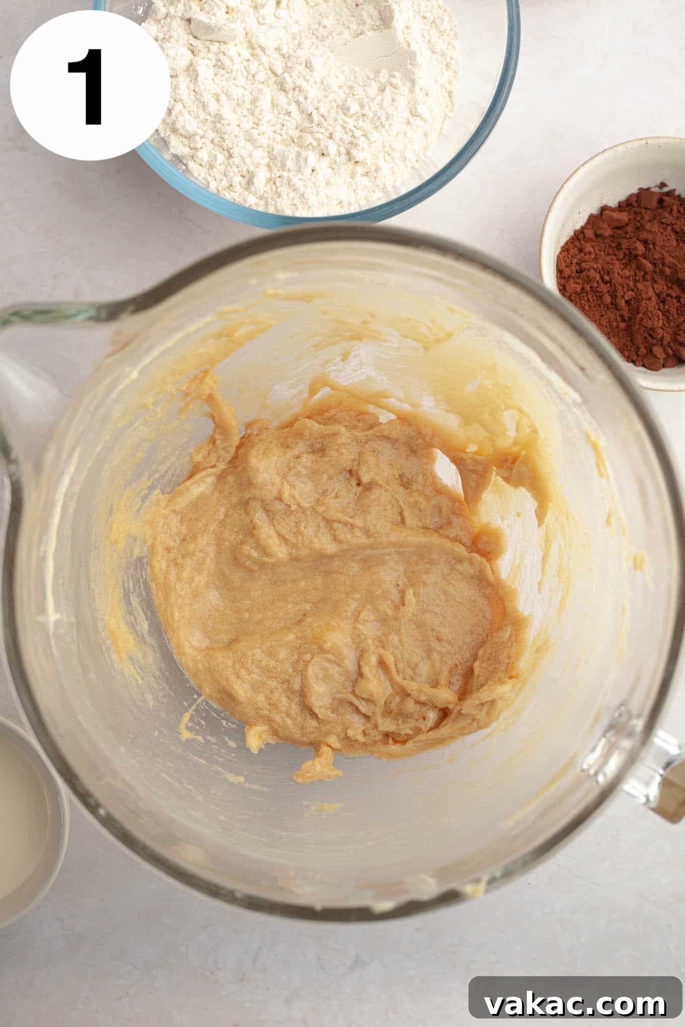 Decadent Chocolate Thumbprint Delights 4 An overhead view of creamed butter, brown sugar, egg, and vanilla in a glass mixing bowl, perfectly combined for the cookie dough.