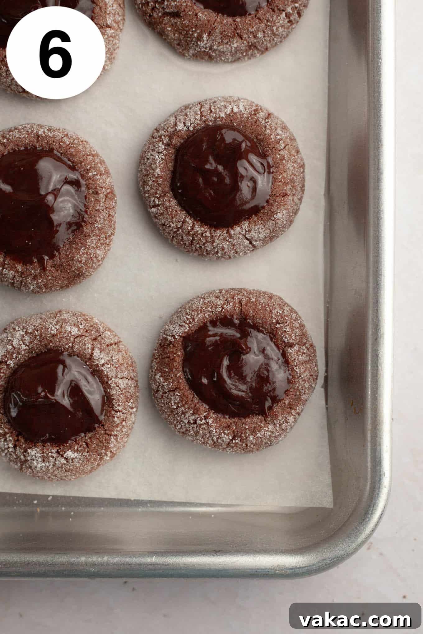 Decadent Chocolate Thumbprint Delights 9 An overhead view of perfectly filled chocolate thumbprints on a parchment-lined baking sheet, waiting for the ganache to set.