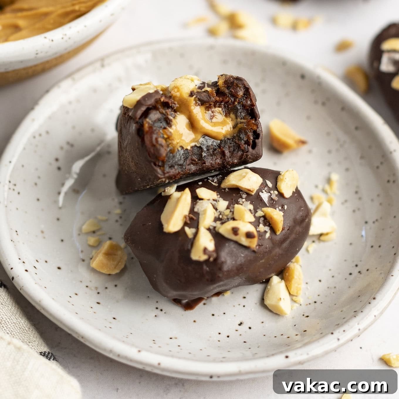 A date snickers on a speckled white plate.