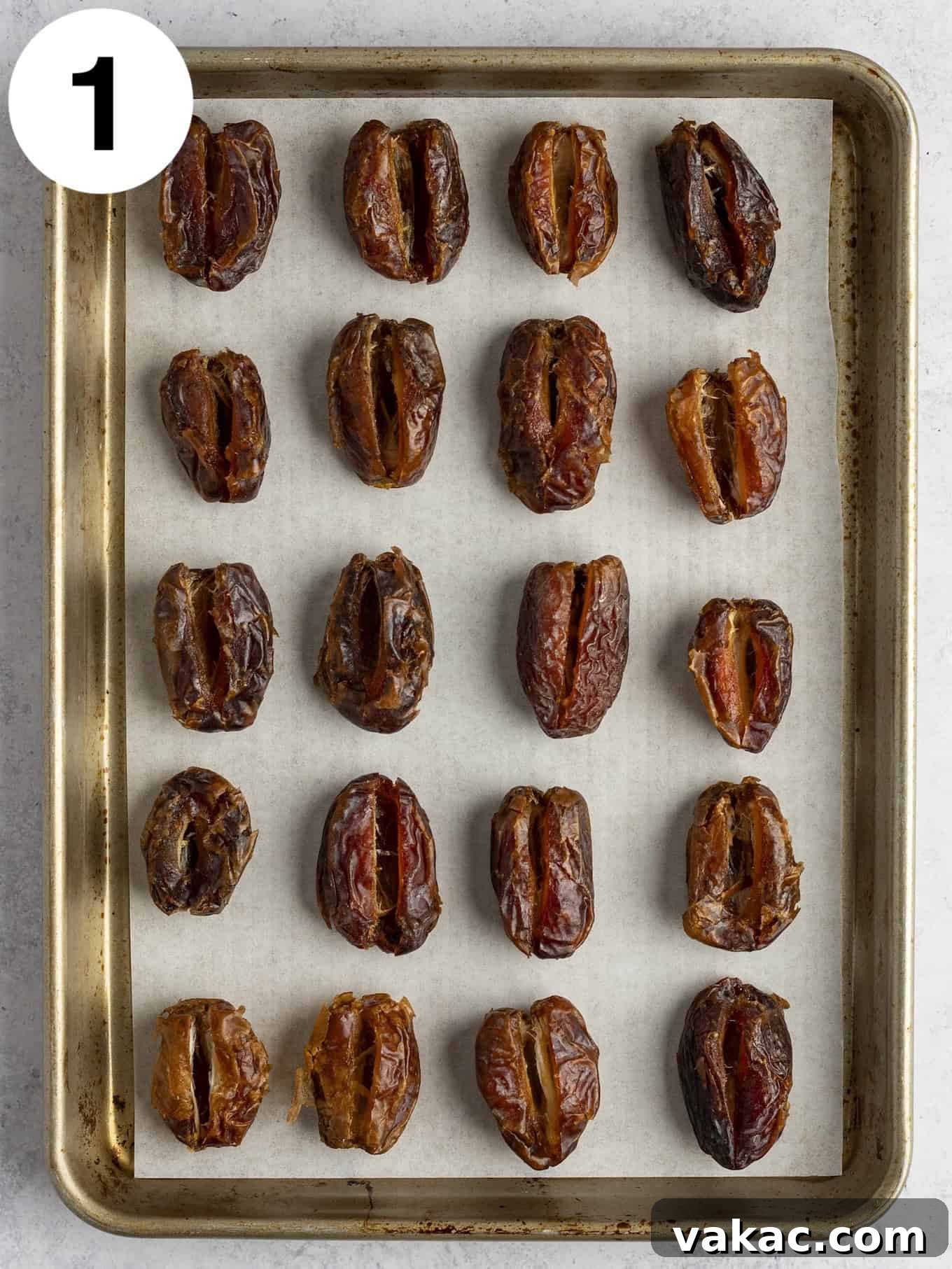 Date Peanut Chocolate Bites 4 An overhead view of pitted dates lined up on a baking sheet.