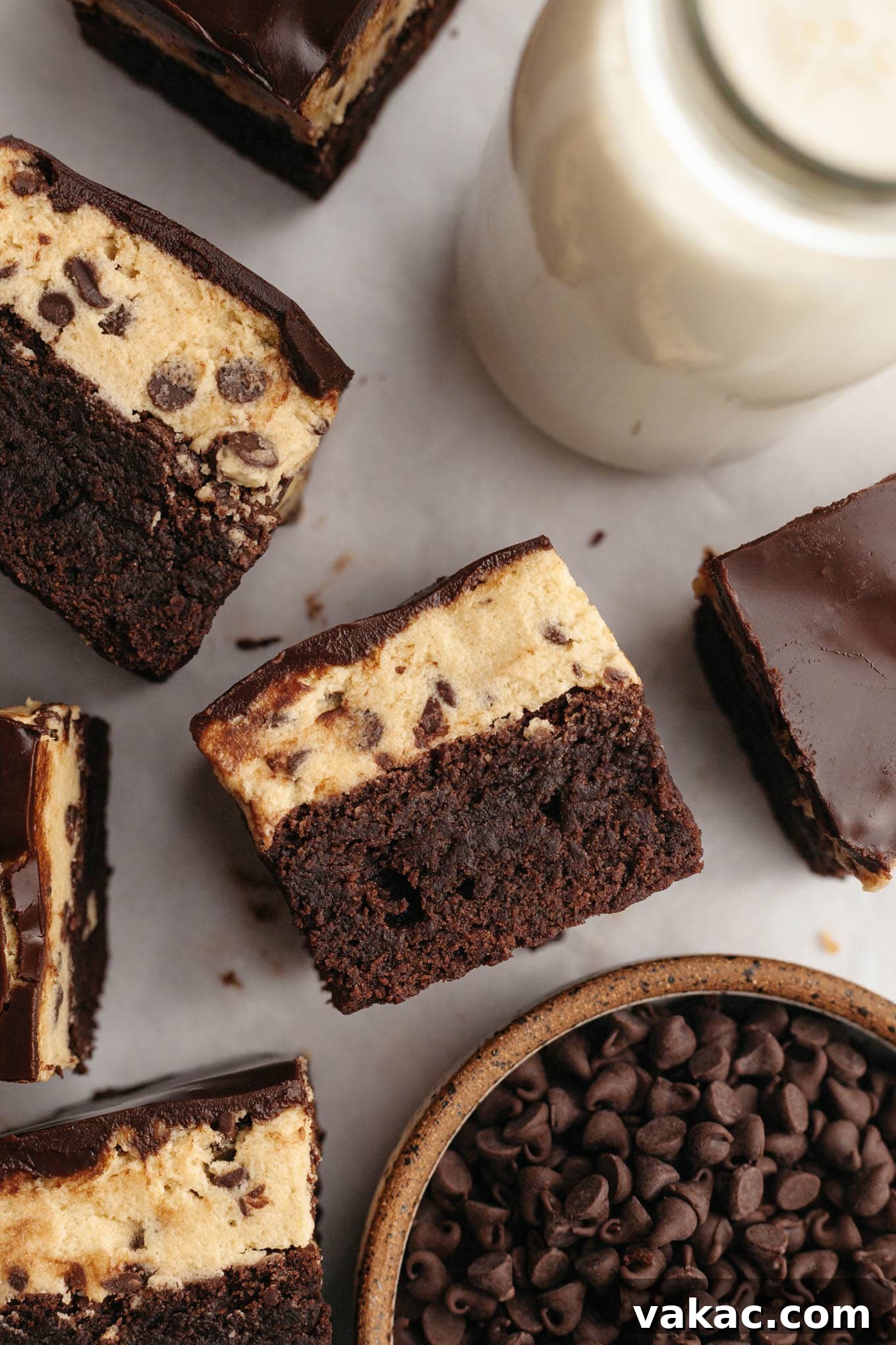 Brownie Cookie Dough Perfection 11 An overhead view of neatly sliced cookie dough brownies, some pieces turned on their sides to show the luscious layers, presented invitingly.