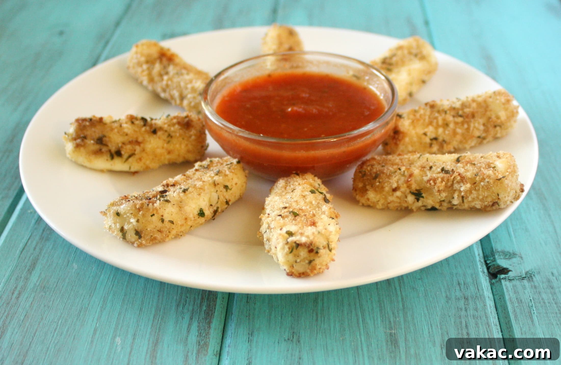 Toasty Mozzarella Perfection 3 Baked Mozzarella Sticks with a beautiful cheese pull, dipped in marinara sauce.