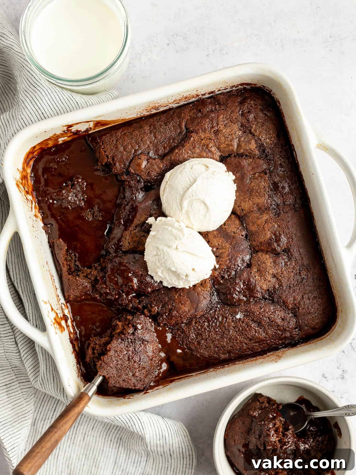 Velvet Chocolate Indulgence 2 An overhead view of fudgy chocolate pudding cake in a baking dish, topped with vanilla ice cream.