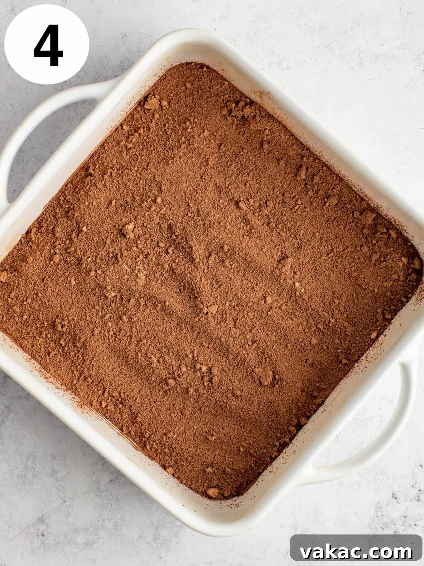 Velvet Chocolate Indulgence 7 An overhead view of chocolate cake batter topped with cocoa powder and brown sugar in a baking dish.