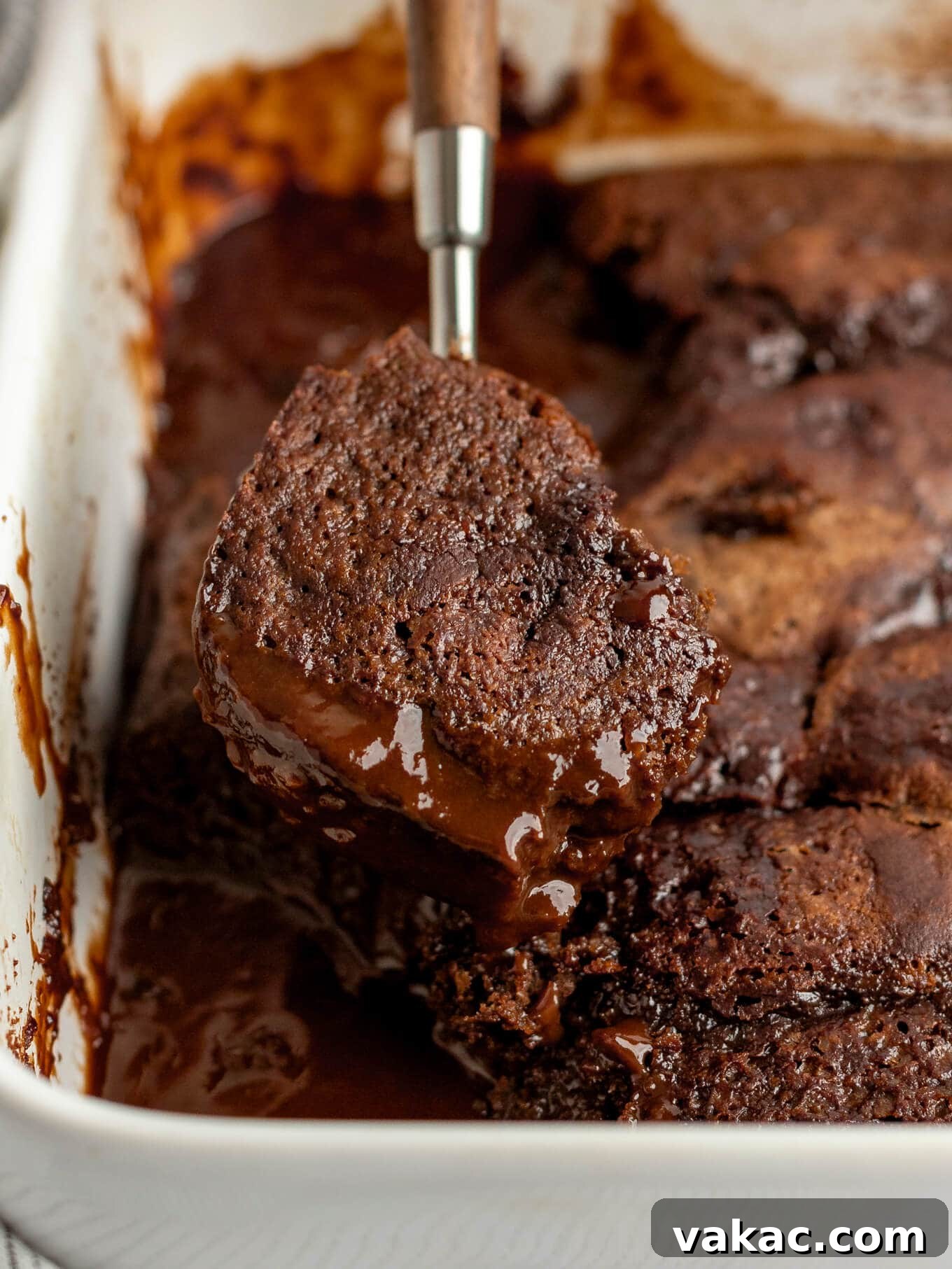 Velvet Chocolate Indulgence 10 A spoonful of chocolate pudding cake being lifted from a baking dish.