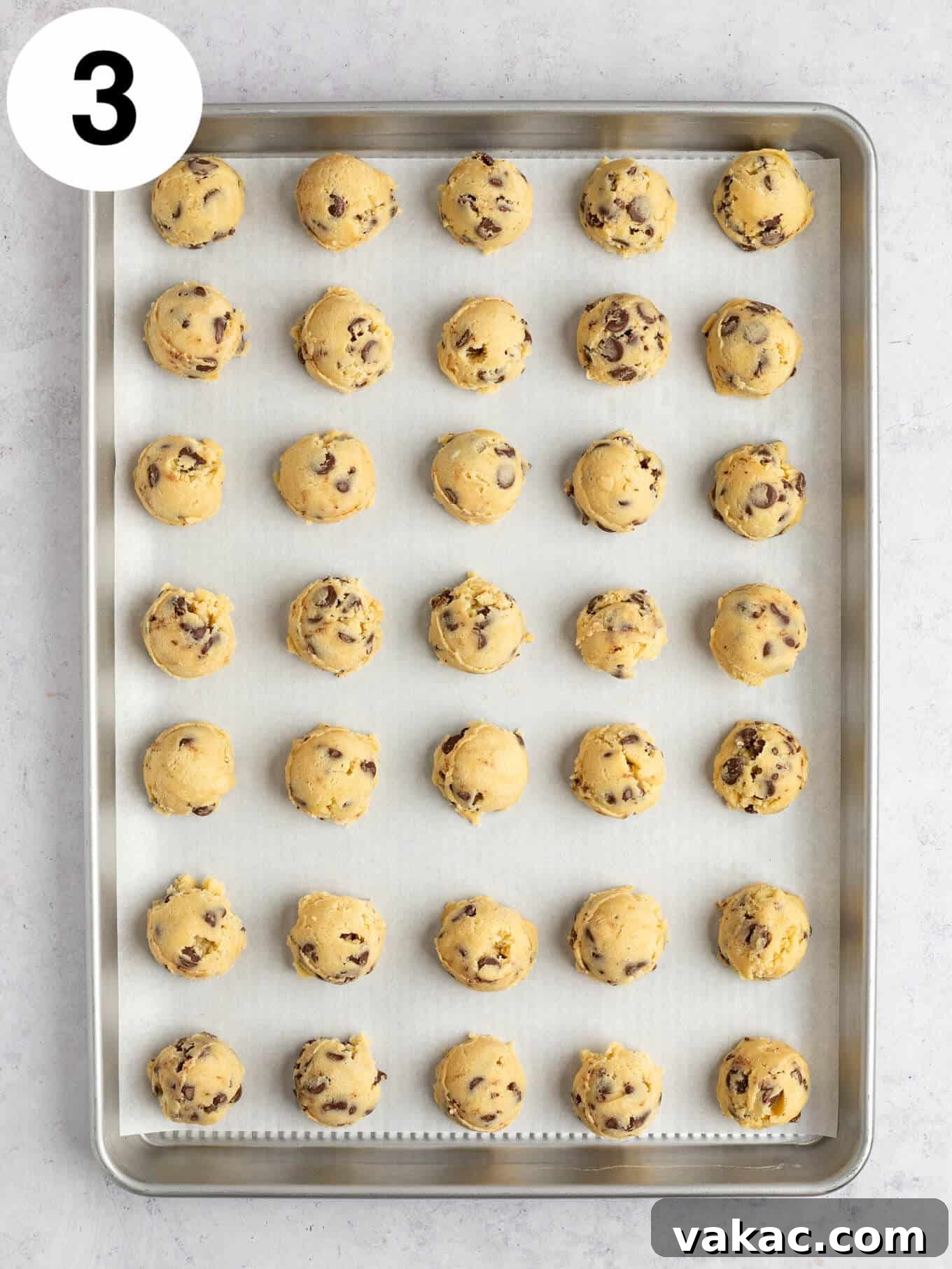 Reese's Peanut Butter Cup Overload Cookies 6 An overhead view of perfectly scooped balls of chocolate chip cookie dough on a baking sheet.