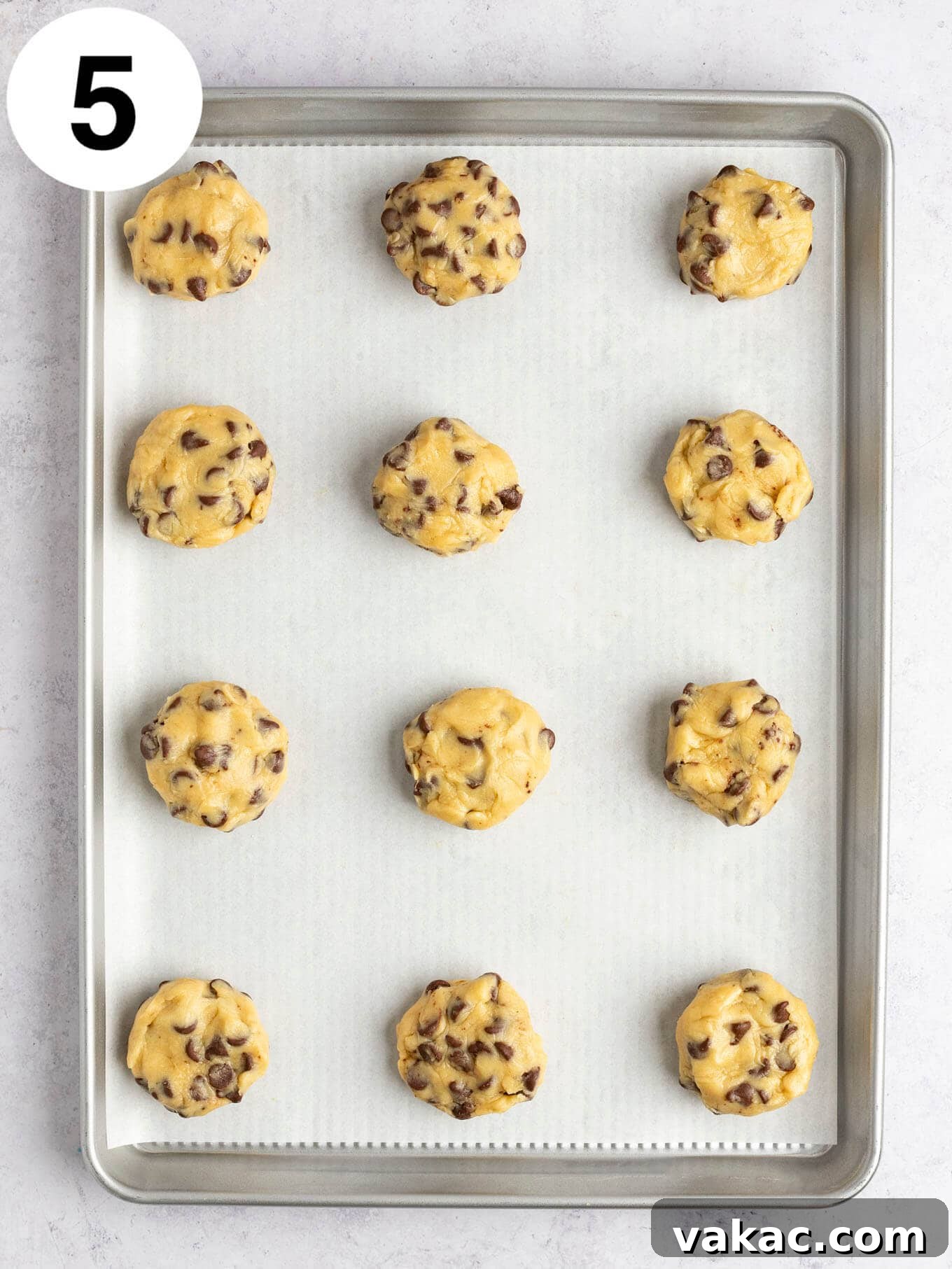 Reese's Peanut Butter Cup Overload Cookies 8 An overhead view of unbaked Reese's stuffed cookies, perfectly formed, on a baking sheet, ready for chilling.