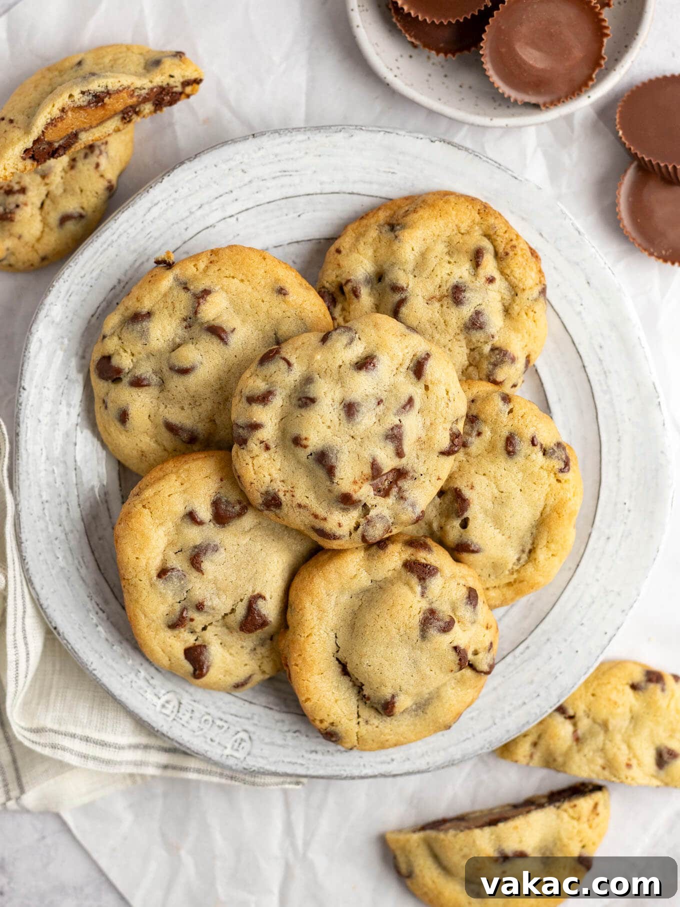 Reese's Peanut Butter Cup Overload Cookies 10 An overhead view of a beautifully arranged plate of freshly baked cookies stuffed with Reese's peanut butter cups.