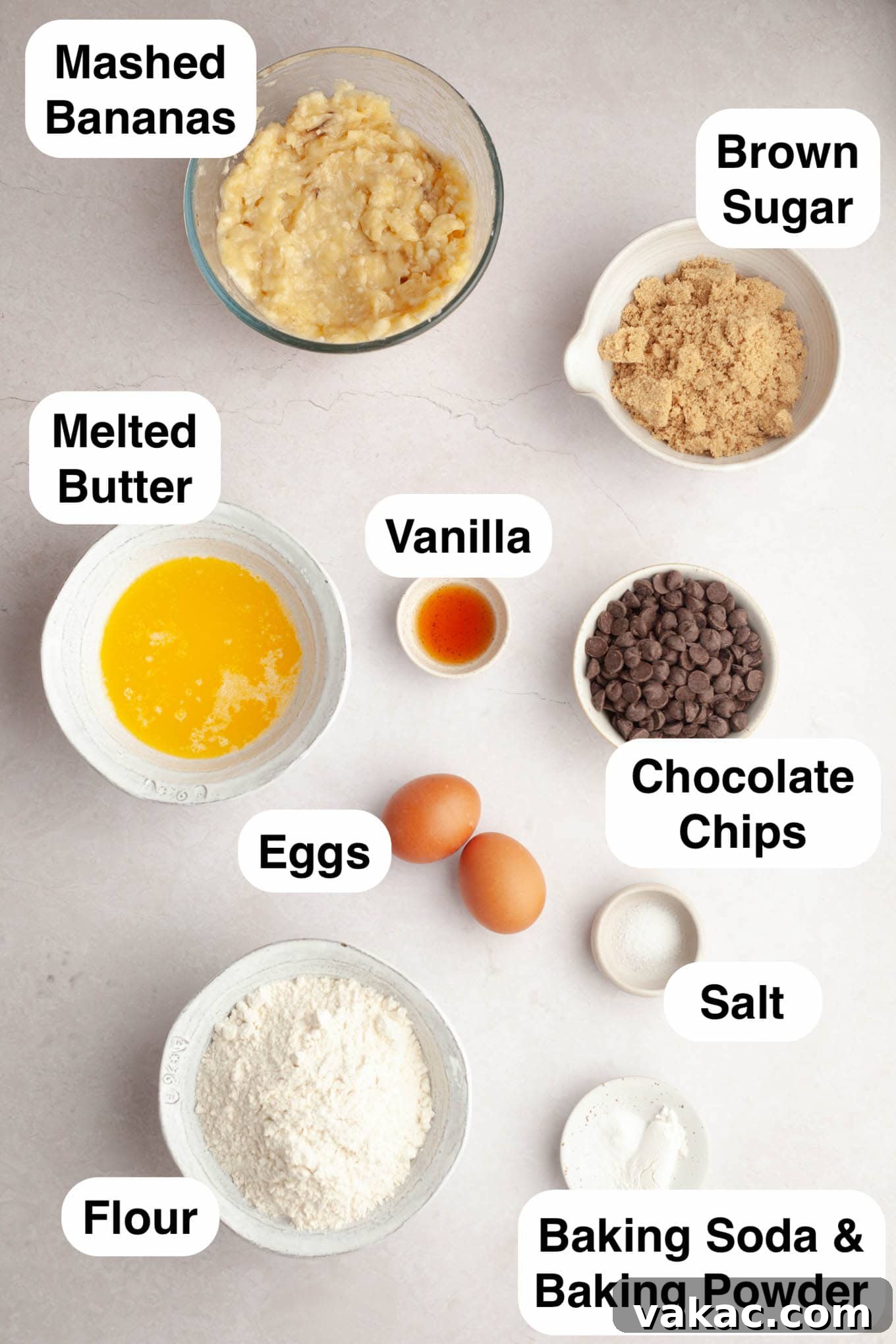 Decadent Chocolate Chip Banana Loaf 3 An overhead view of all the essential ingredients laid out on a clean surface, ready to be combined for chocolate chip banana bread: flour, sugar, butter, eggs, bananas, and chocolate chips.