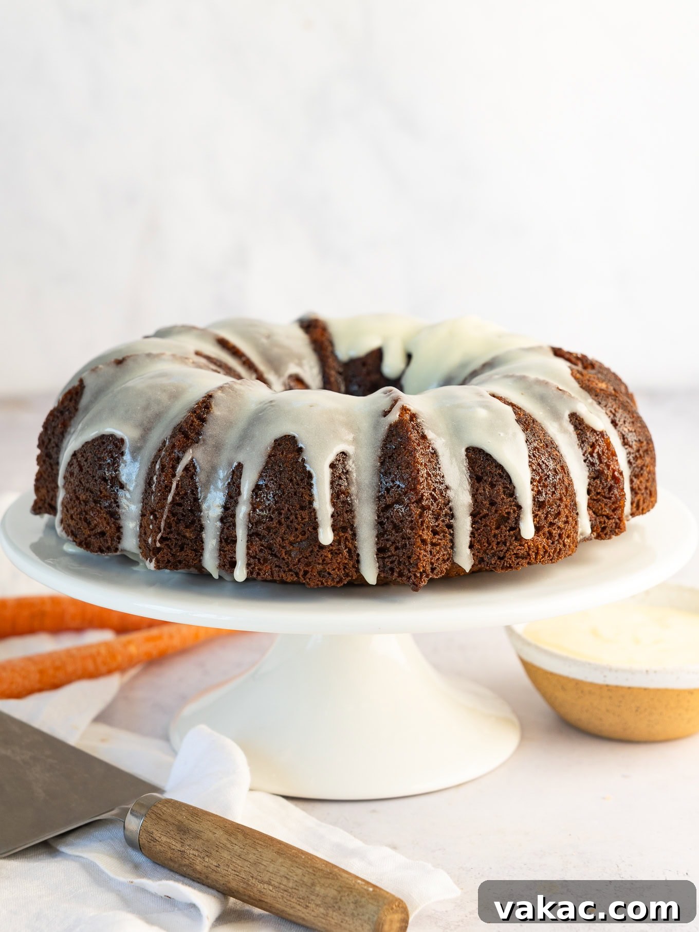 A beautifully iced carrot bundt cake, ready to be served.