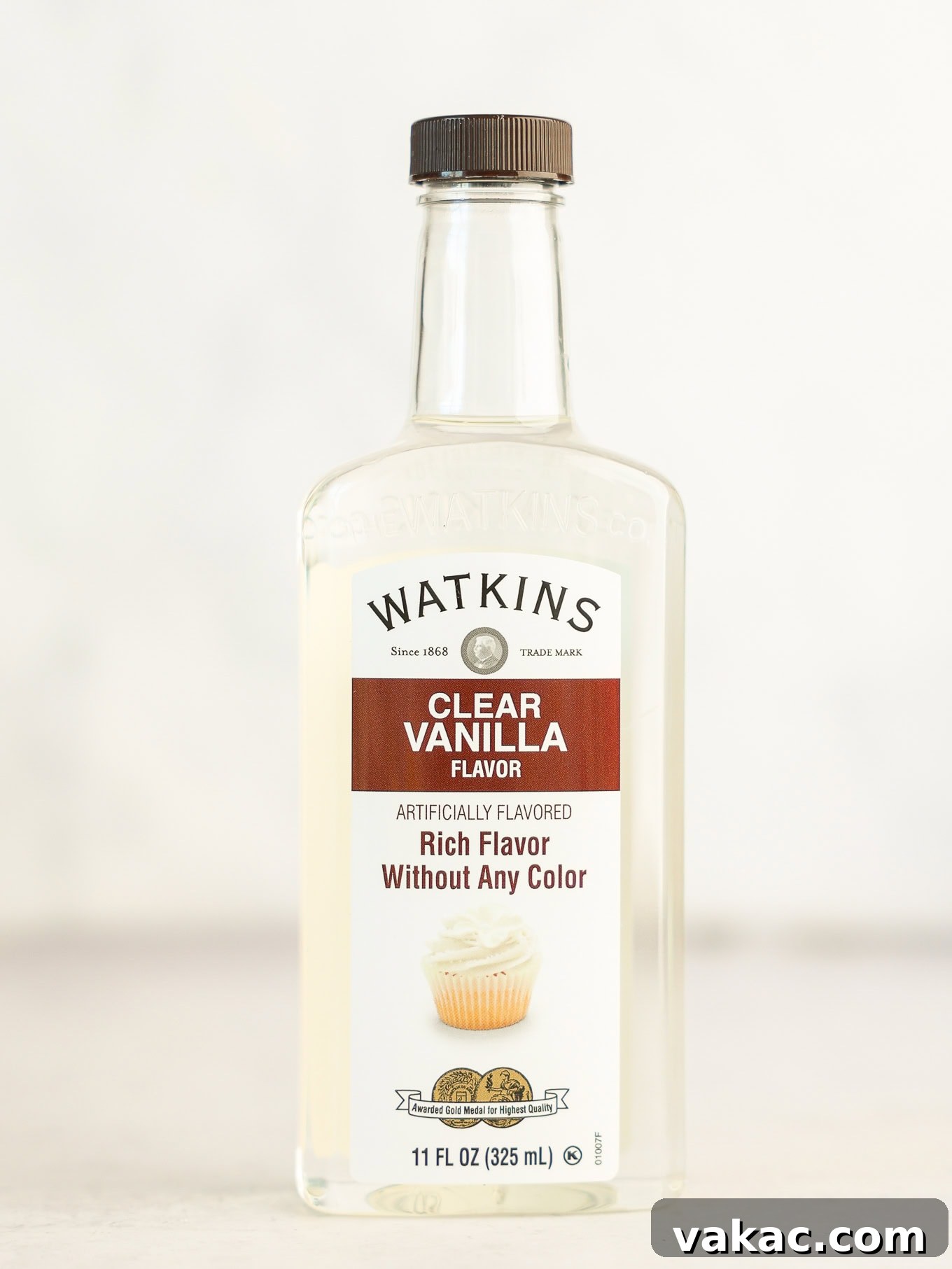 Fluffy White Cupcakes 4 A bottle of clear vanilla extract, crucial for maintaining the pure white color of the cupcakes.