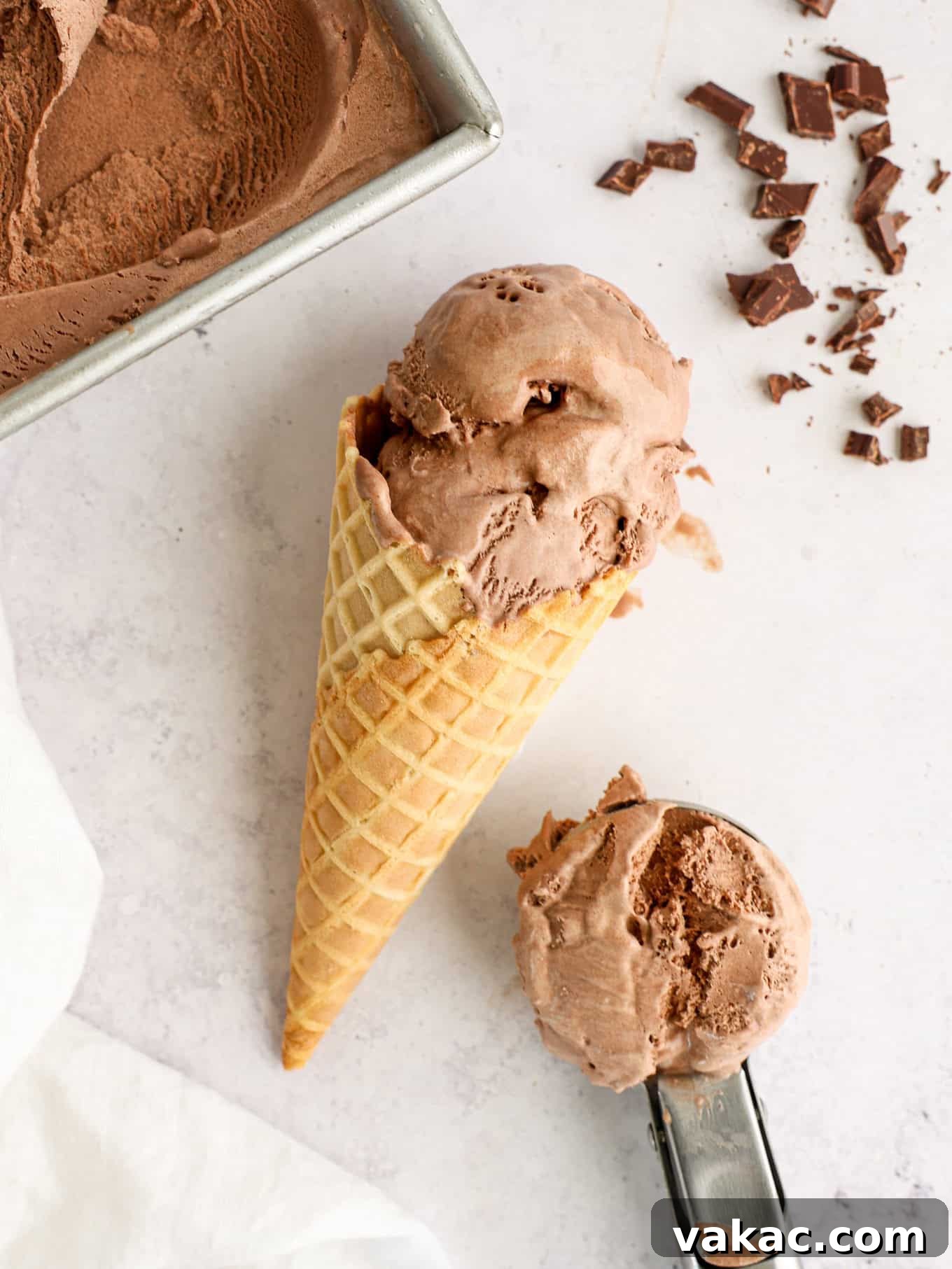Decadent Chocolate Bliss 2 A scoop of rich homemade chocolate ice cream in a waffle cone, resting on its side.