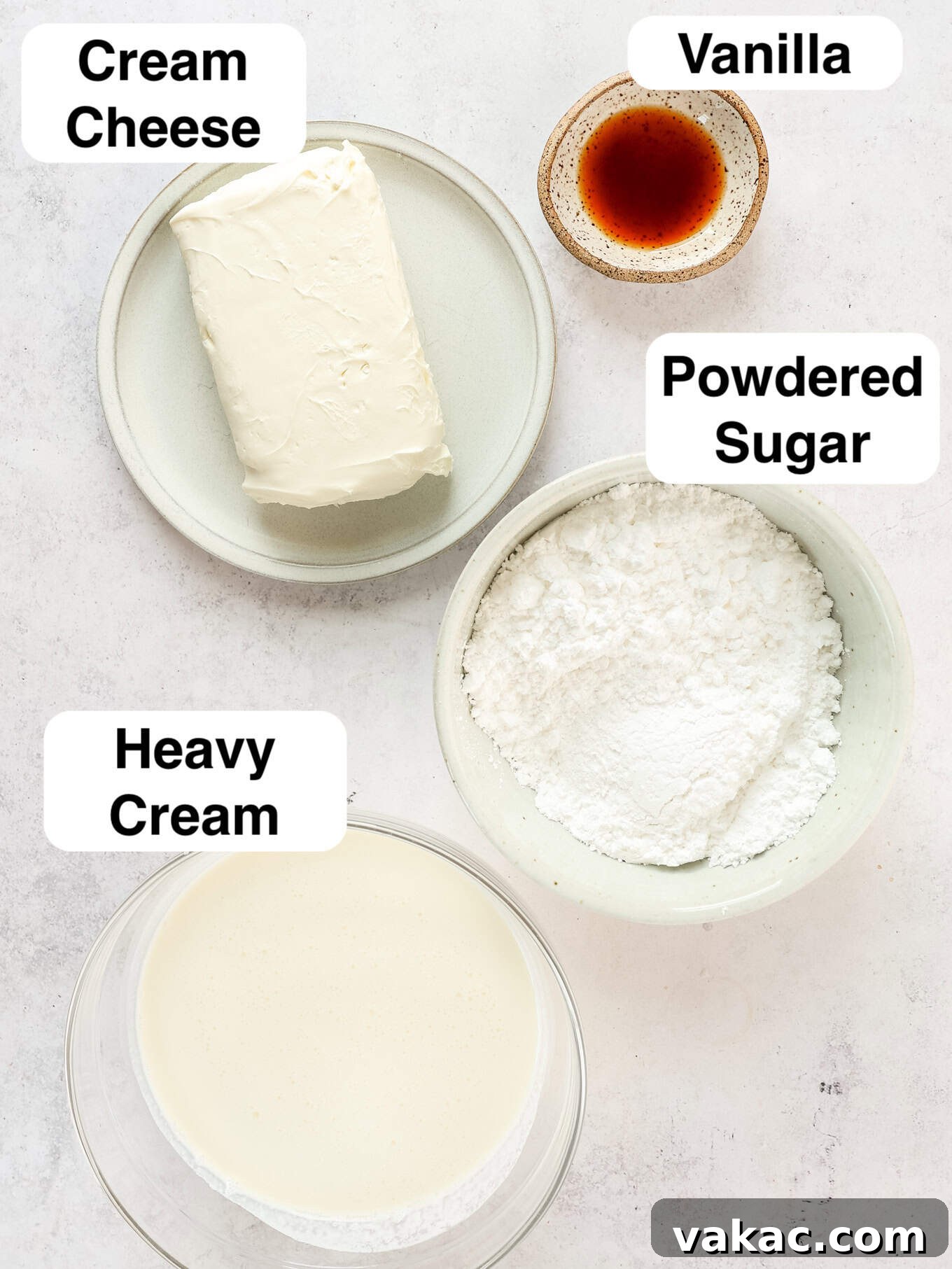 Fluffy Cream Cheese Cloud 3 A collection of essential ingredients for crafting the perfect whipped cream cheese frosting, including blocks of cream cheese, powdered sugar, vanilla extract, and heavy whipping cream, arranged neatly on a surface.