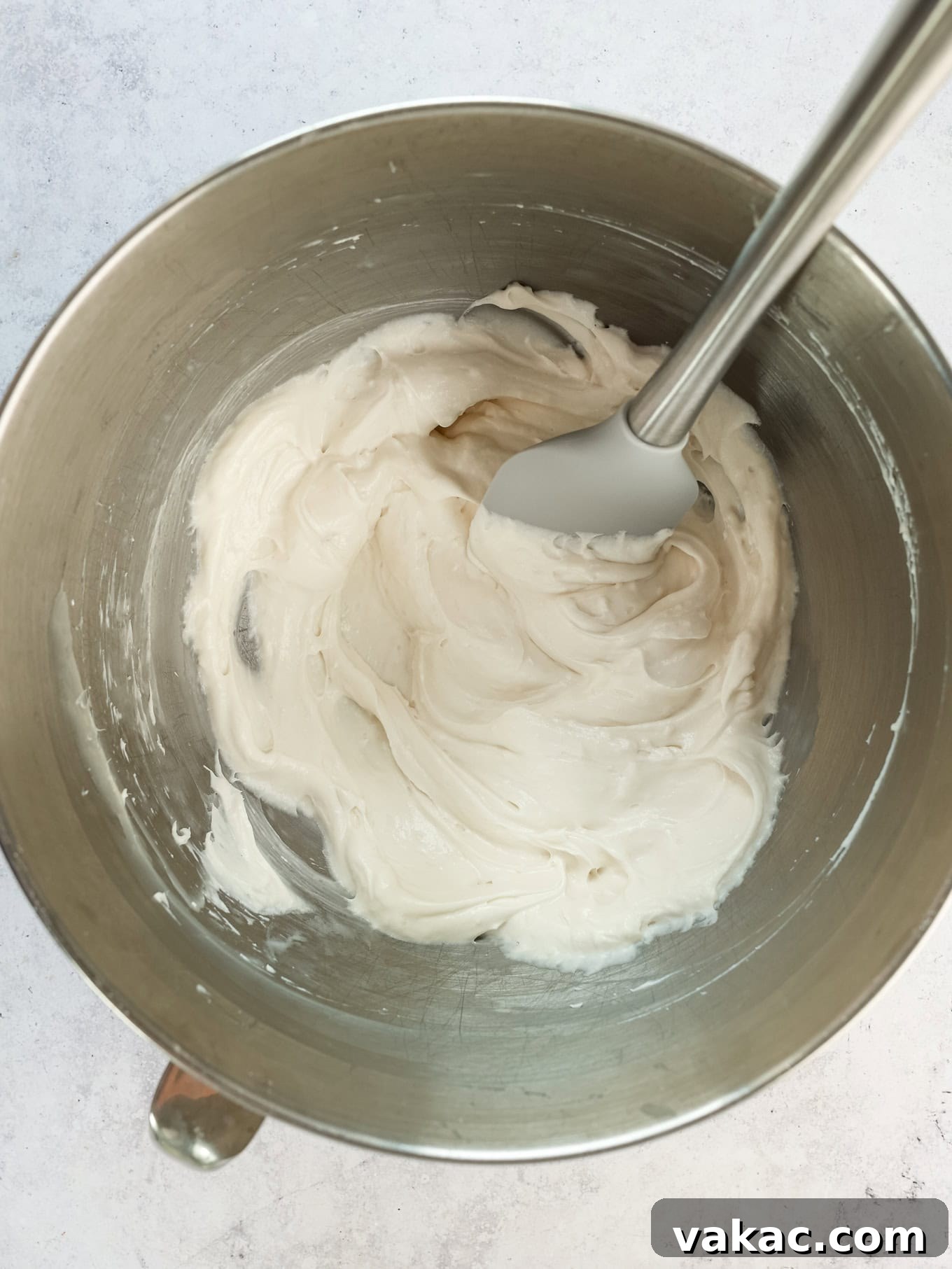 Fluffy Cream Cheese Cloud 5 An overhead view of a bowl containing a smooth, creamy beaten cream cheese mixture, ready for the next step in making whipped cream cheese frosting.