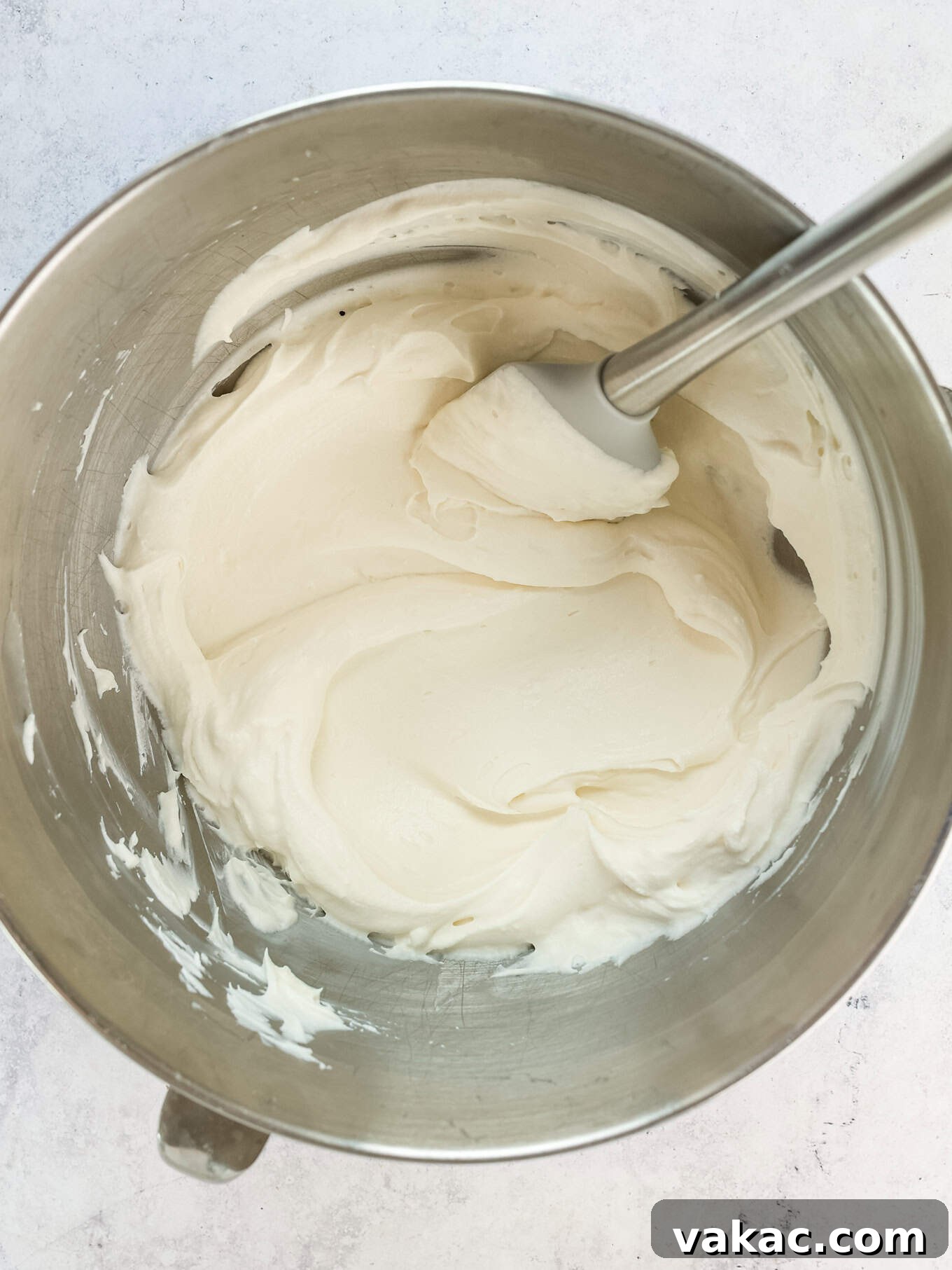 Fluffy Cream Cheese Cloud 6 An overhead shot of a bowl filled with perfectly mixed whipped cream cheese frosting, showcasing its light, airy texture and ready for piping or spreading onto baked goods.