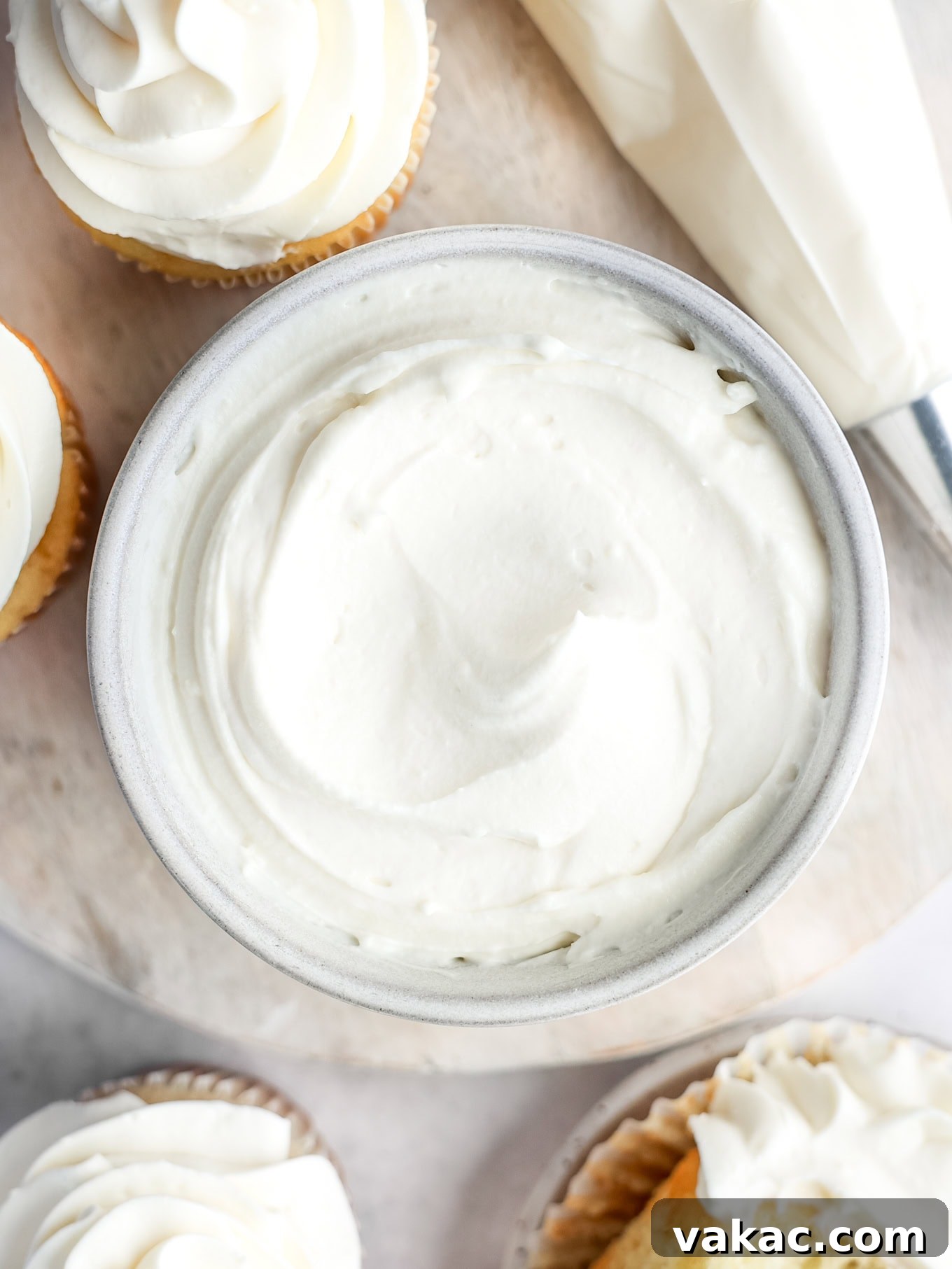 Fluffy Cream Cheese Cloud 7 An inviting overhead view of a bowl filled with perfectly light and airy whipped cream cheese frosting, ready for its delicious purpose, highlighting its smooth and fluffy texture.