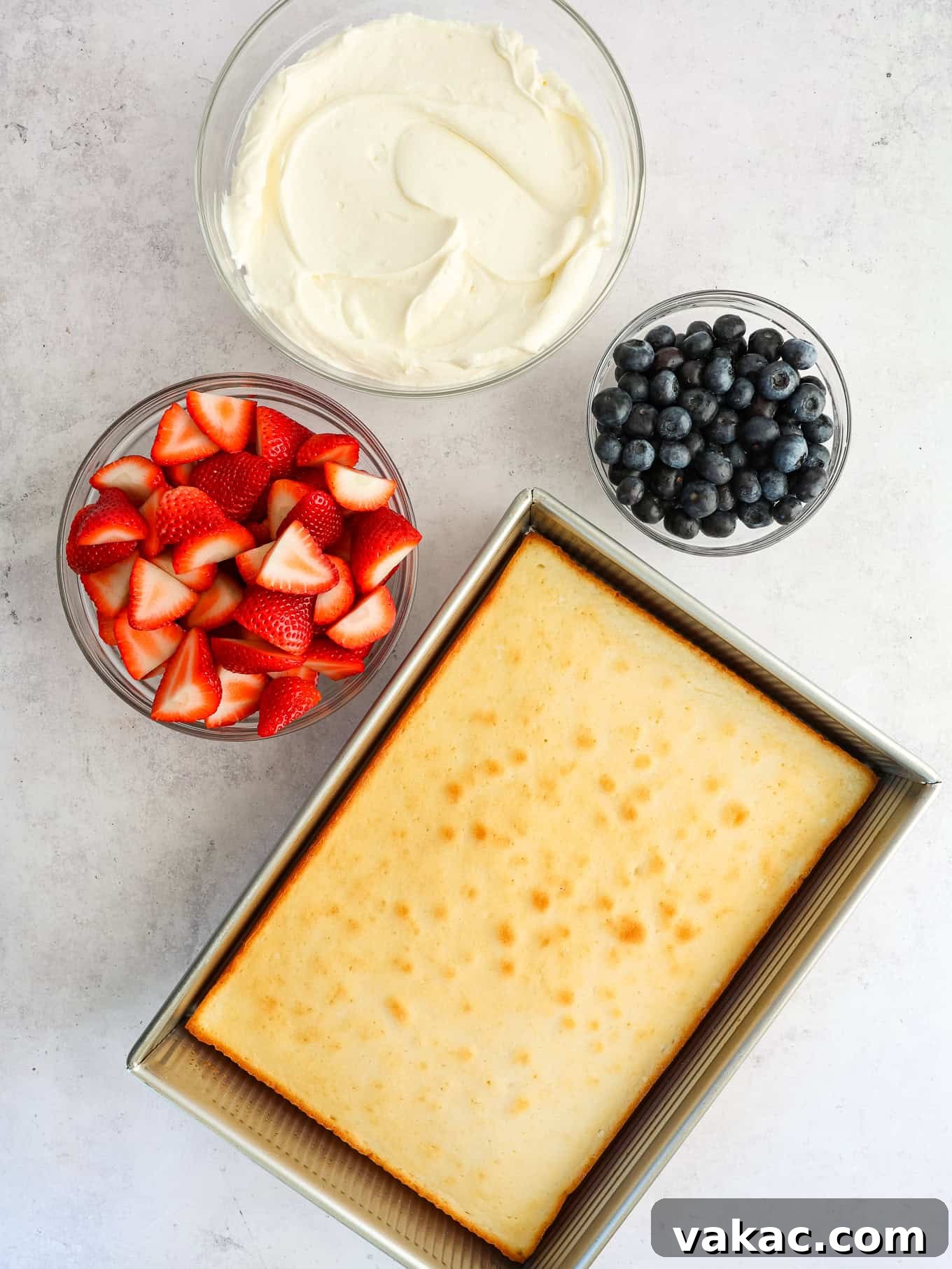 Patriotic Celebration Cake 3 A white cake, fresh berries, and whipped cream cheese frosting ingredients laid out.