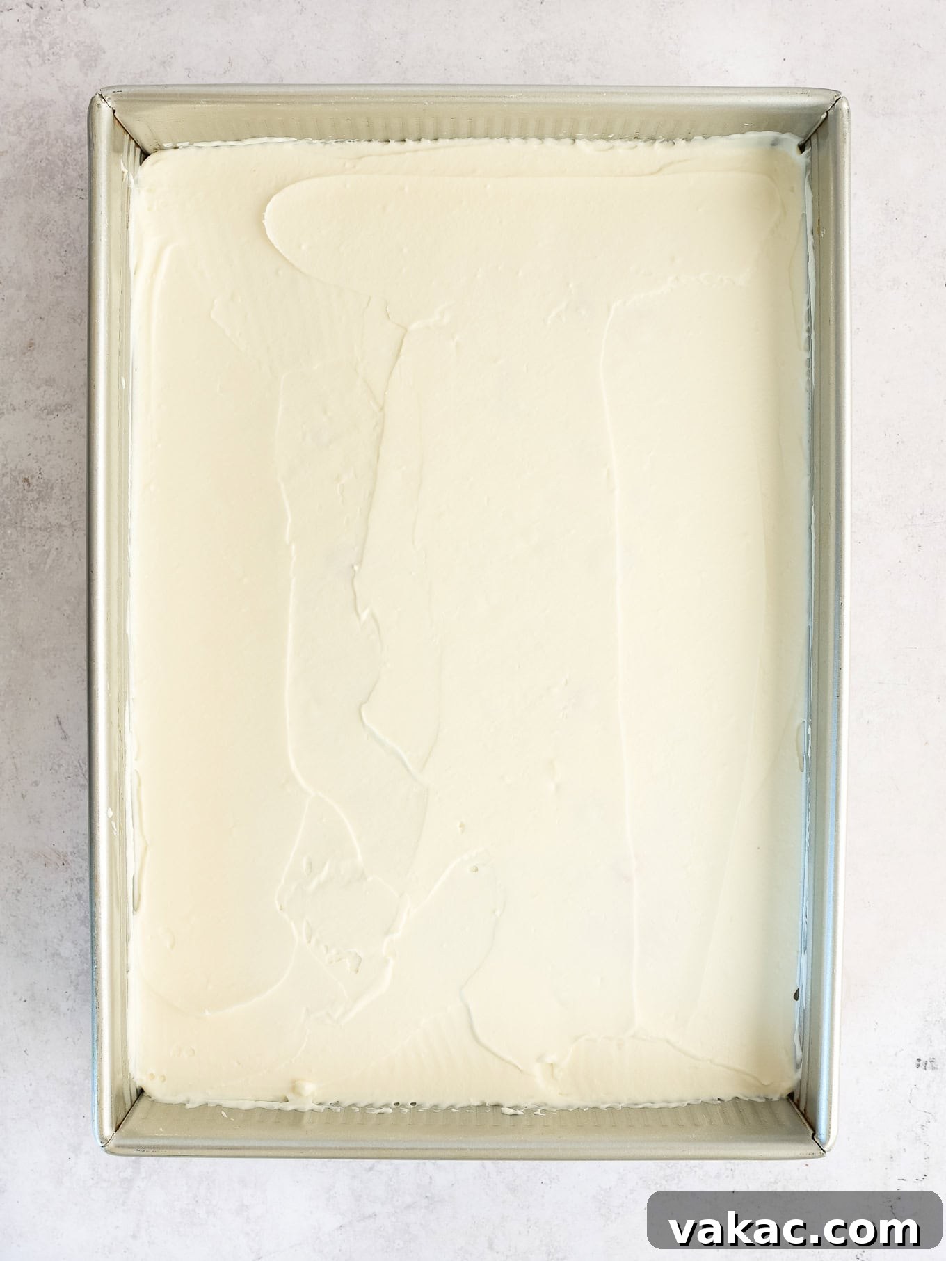 Patriotic Celebration Cake 4 A plain white cake in a 9x13 pan topped with frosting.