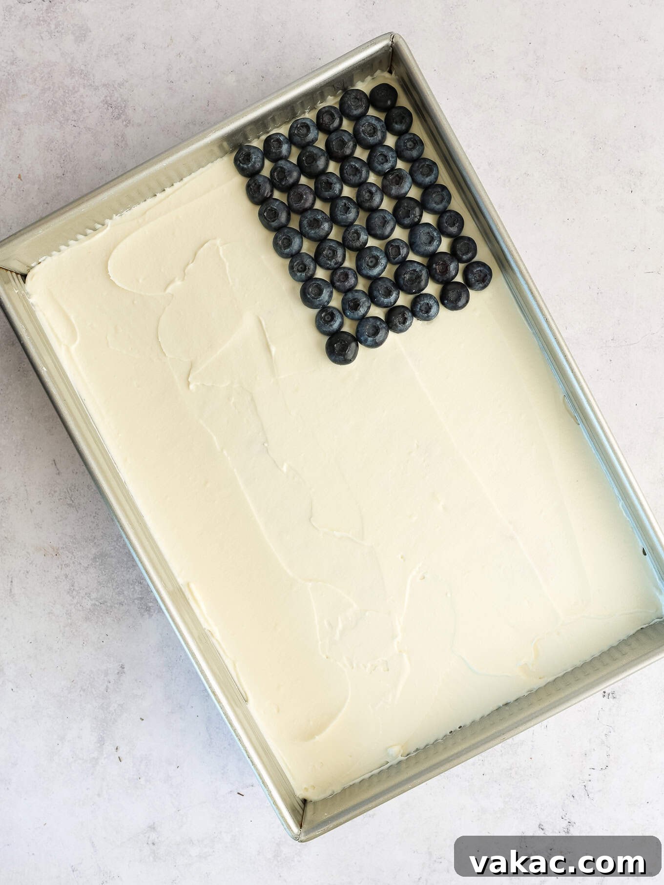 Patriotic Celebration Cake 5 A white frosted cake with a rectangle of blueberries at the top.