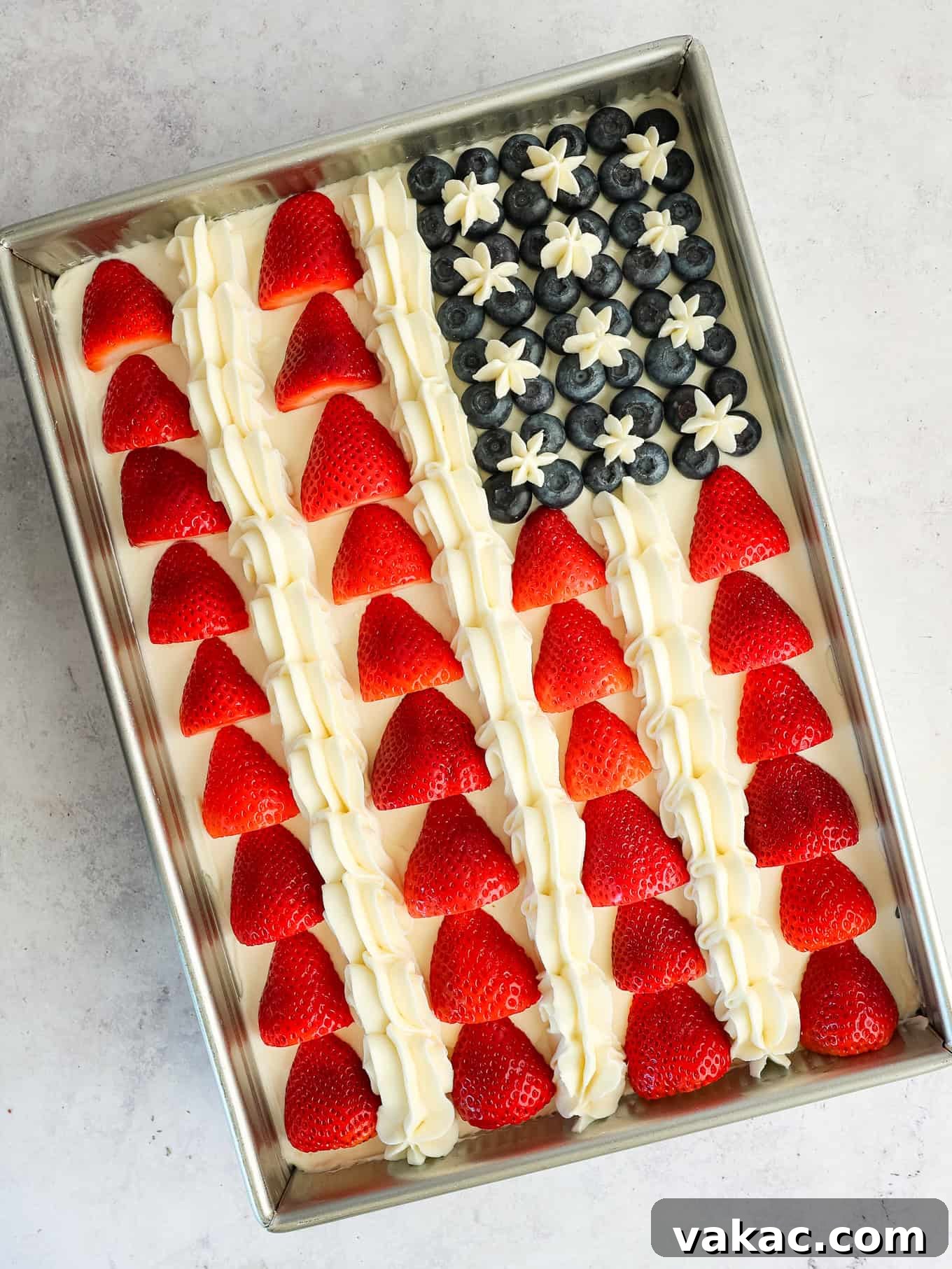 Patriotic Celebration Cake 7 An American flag cake decorated with strawberries, blueberries, and frosting stars.