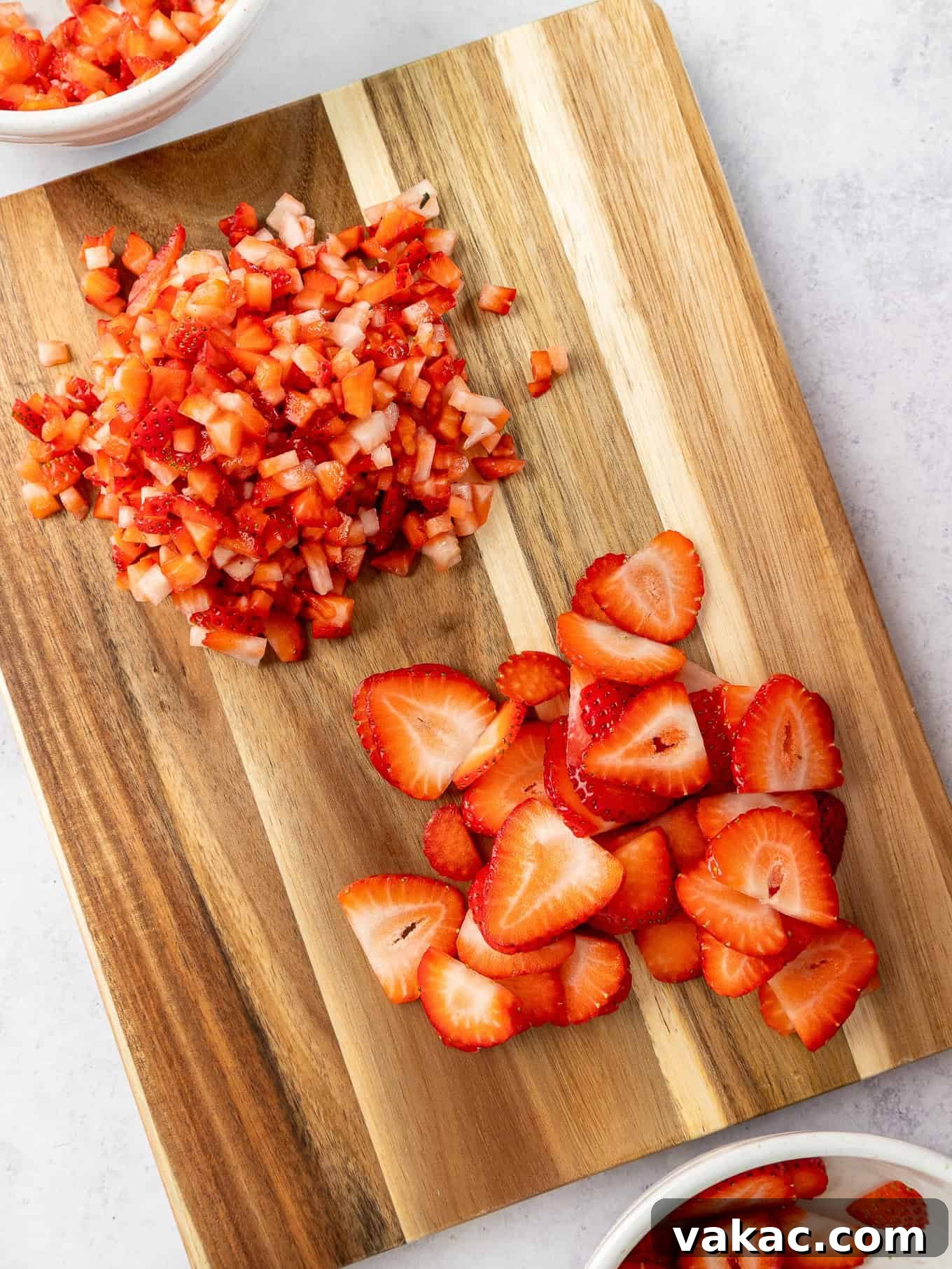 Strawberry Dream Cheesecake 4 Chopped and sliced fresh strawberries on a cutting board, ready for the topping.