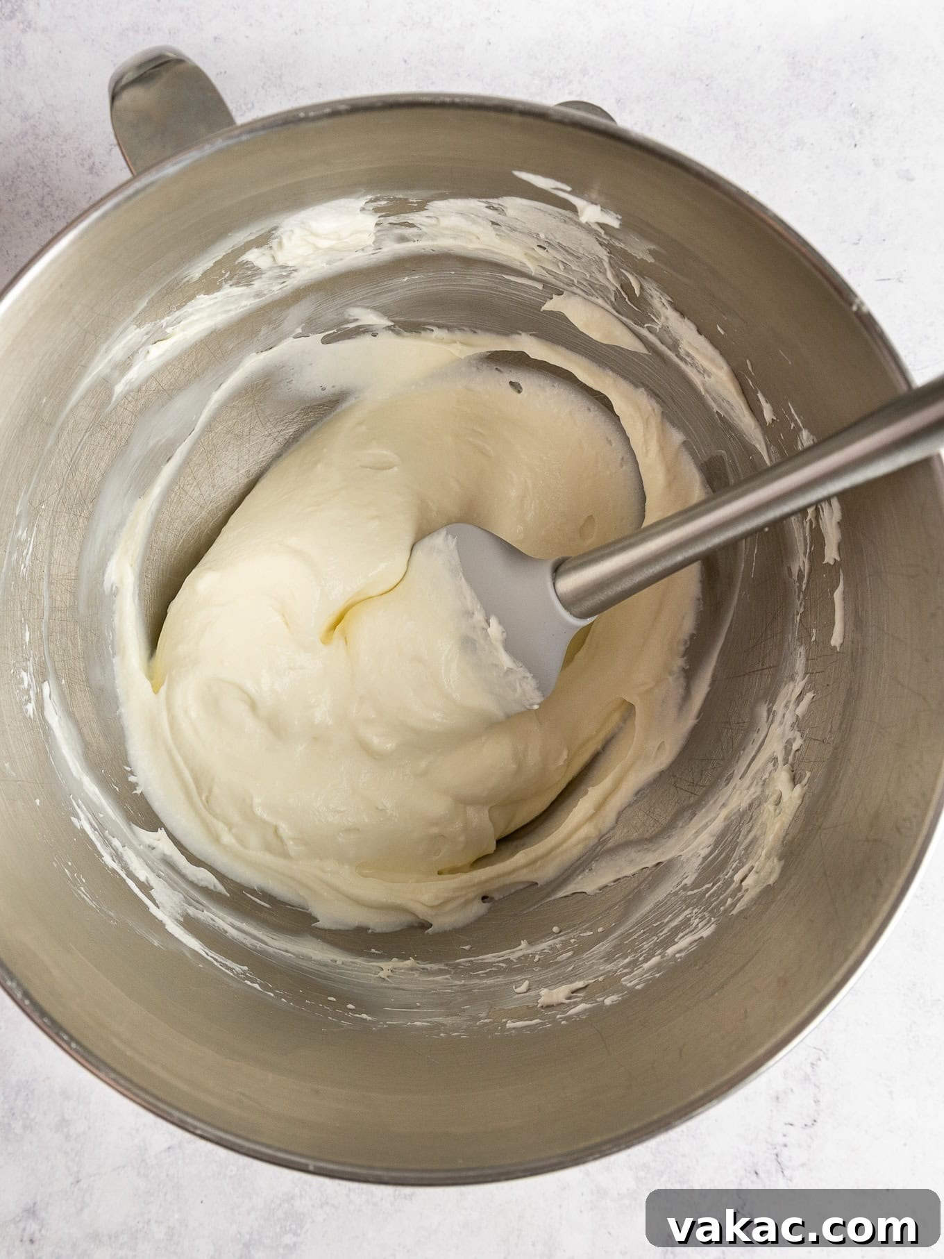 Strawberry Dream Cheesecake 8 An overhead view of no-bake cheesecake filling in a mixing bowl, smooth and creamy.