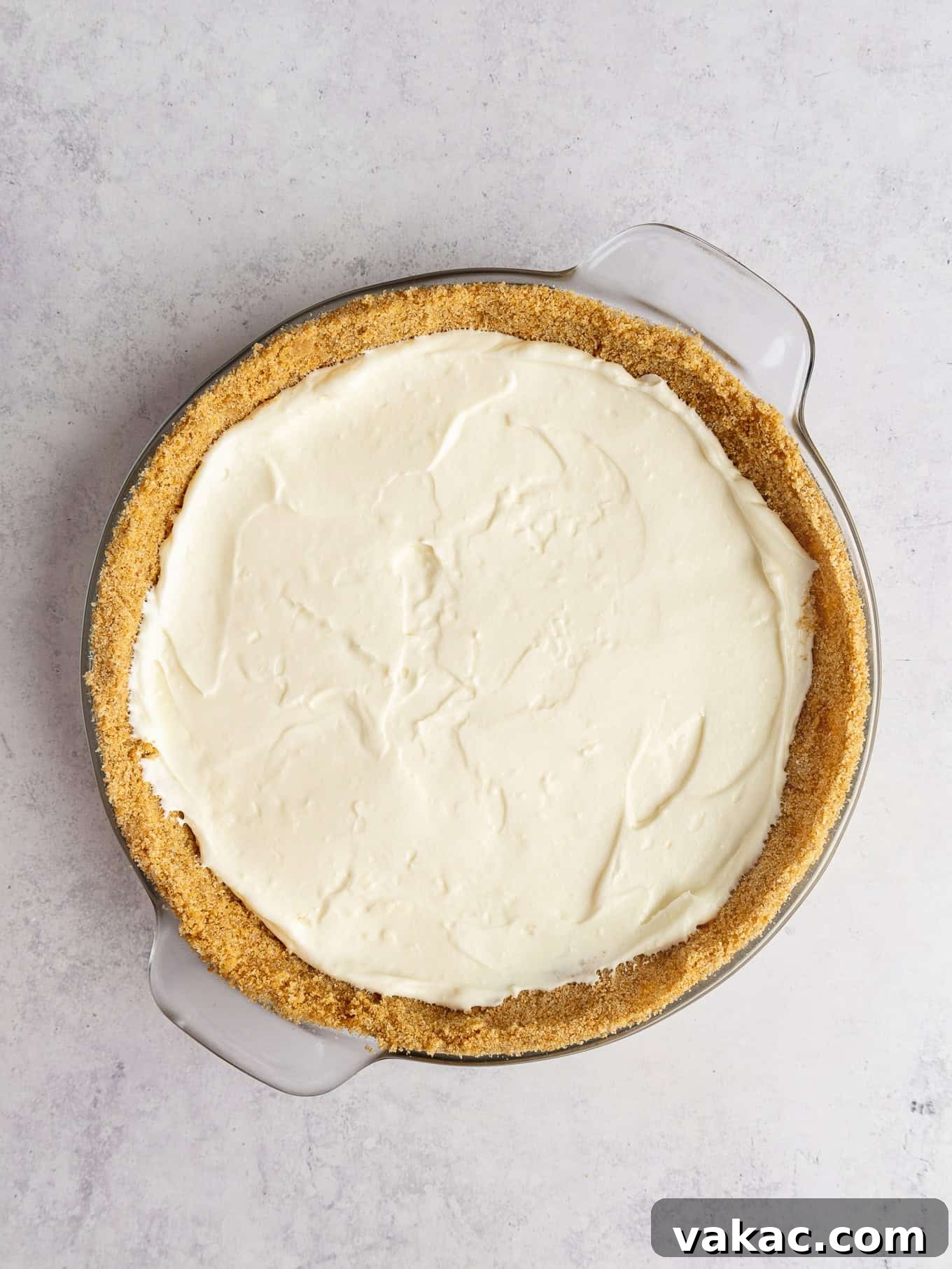 Strawberry Dream Cheesecake 9 An overhead view of the creamy cream cheese filling spread evenly into a graham cracker crust.