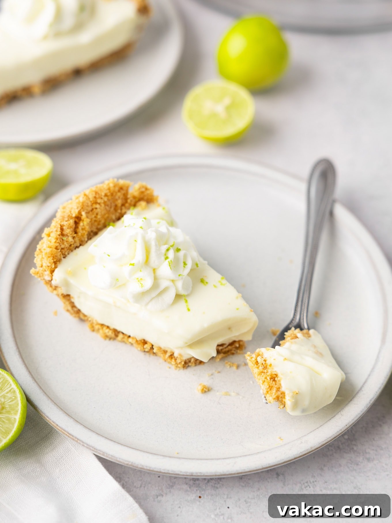 Sunshine Key Lime Bliss 9 A slice of no bake key lime pie on a plate with a fork.