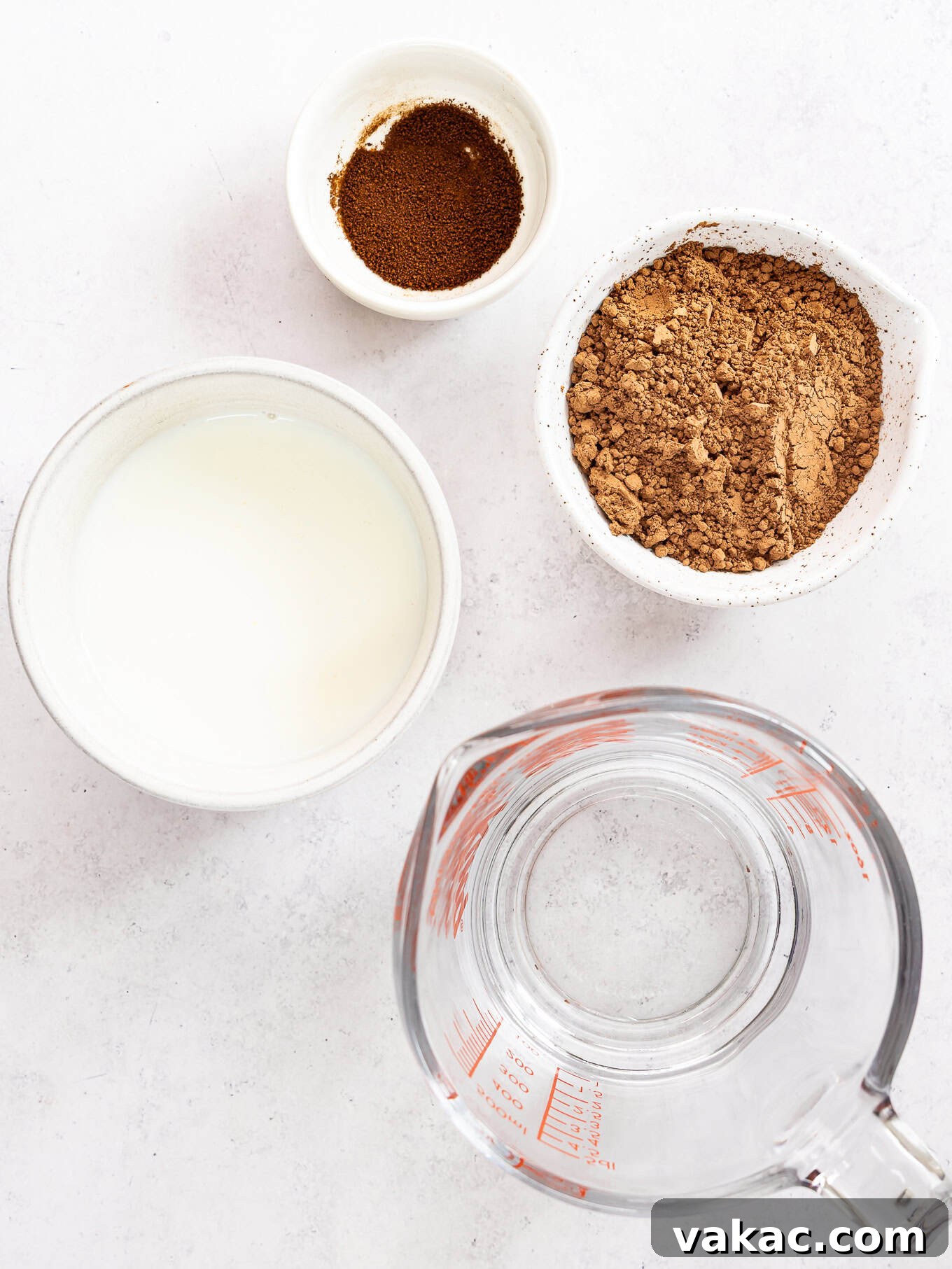 Mini Indulgence 3 Bowls of essential ingredients: buttermilk, instant espresso powder, hot water, and natural cocoa powder, ready for baking this small chocolate cake.