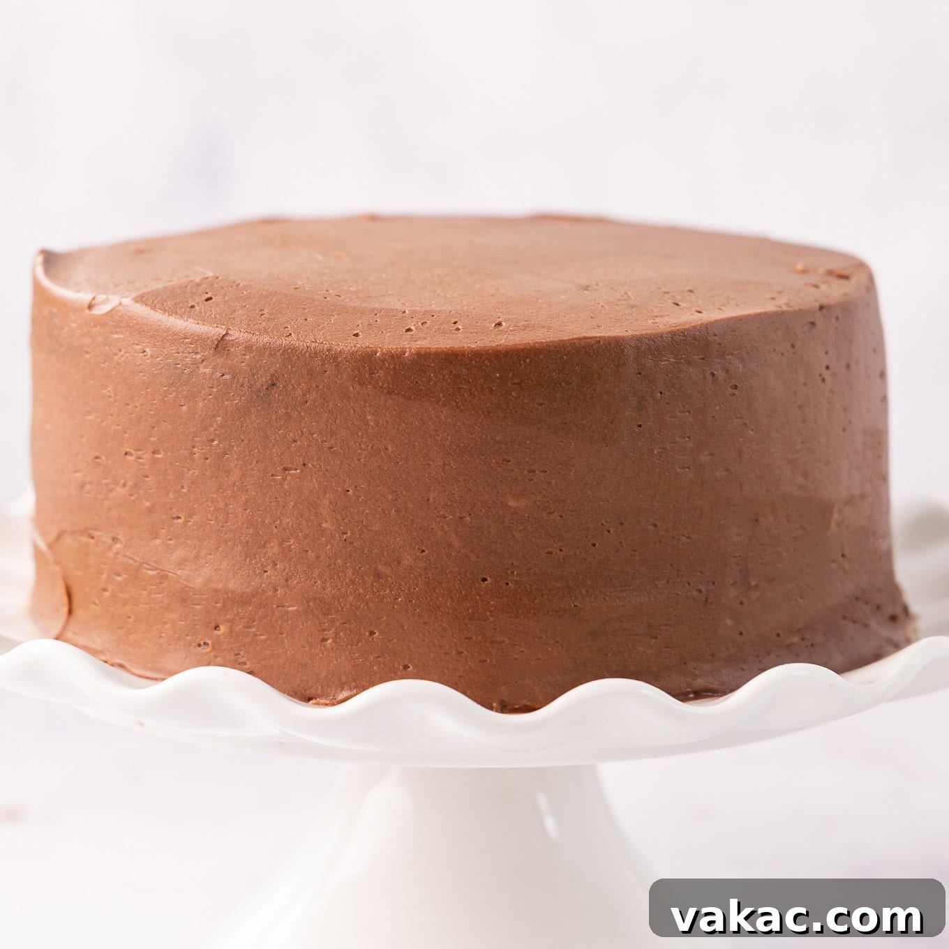 Mini Indulgence 9 A fully frosted small chocolate cake, showcasing smooth chocolate buttercream for a simple yet elegant finish.