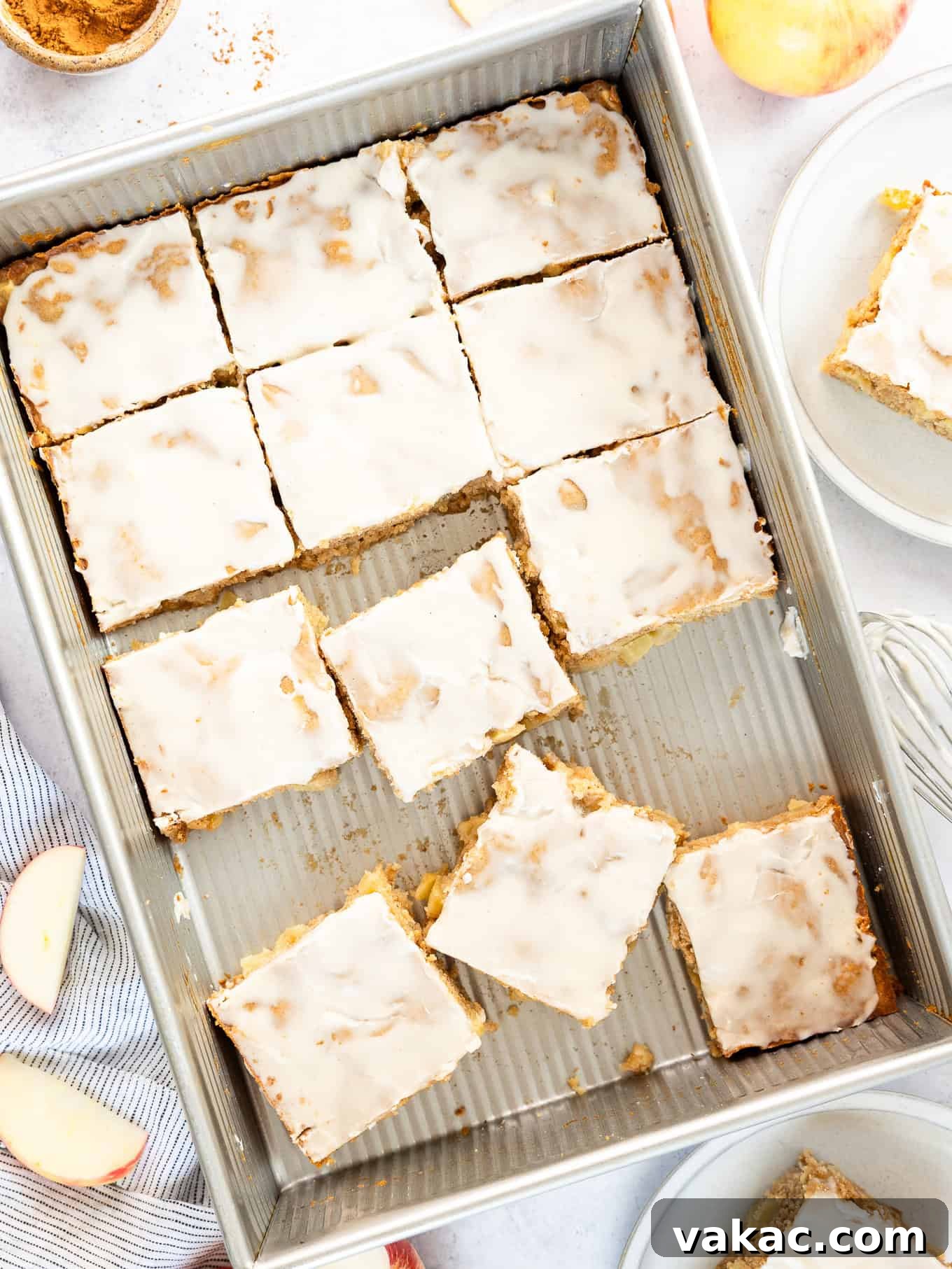 Spiced Apple Fritter Bake 7 A sliced apple fritter cake in a 9x13 pan, showing its perfect golden crust and moist interior.
