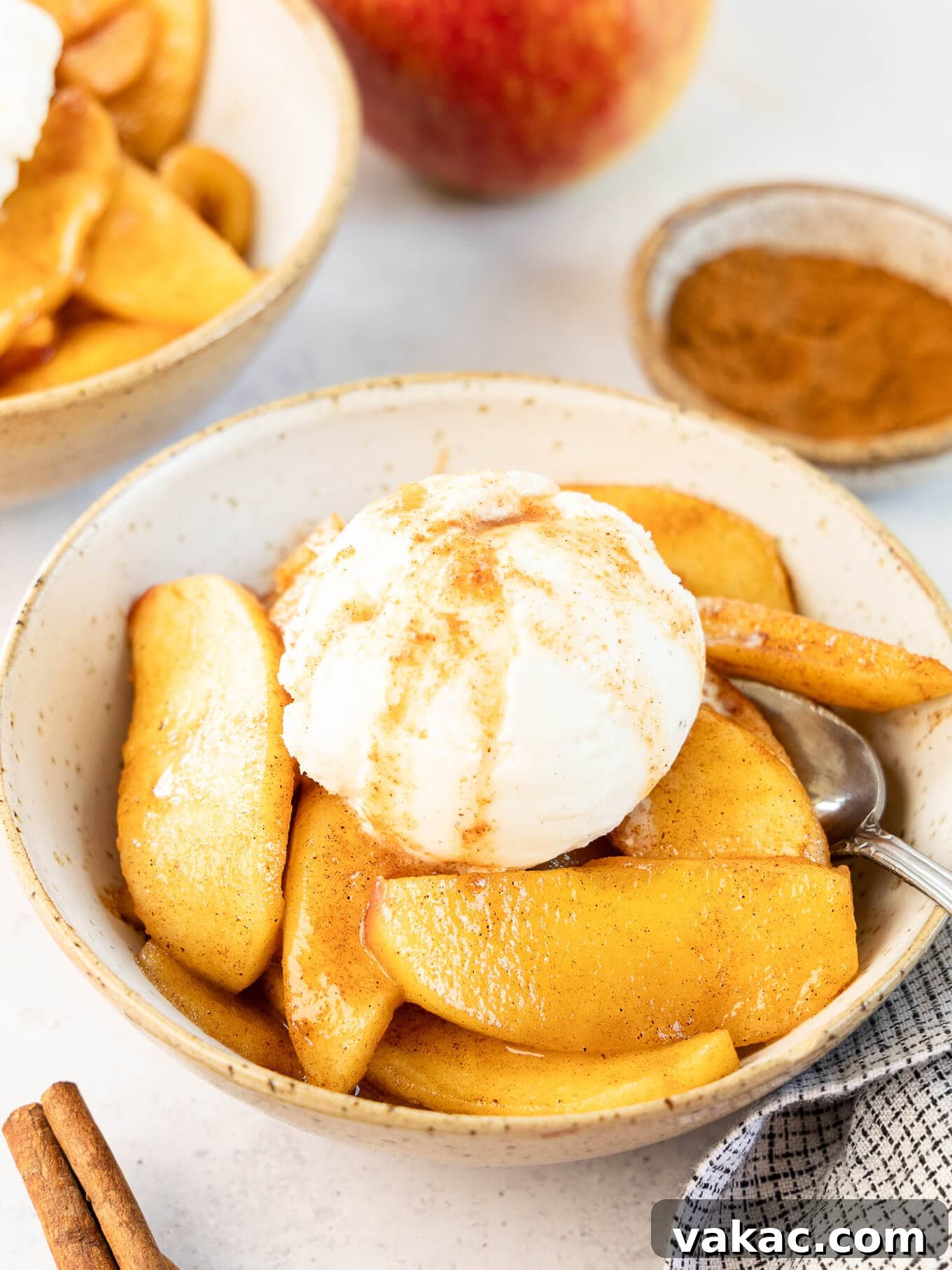 Sweet Skillet Apples 2 A bowl of fried apples topped with ice cream.
