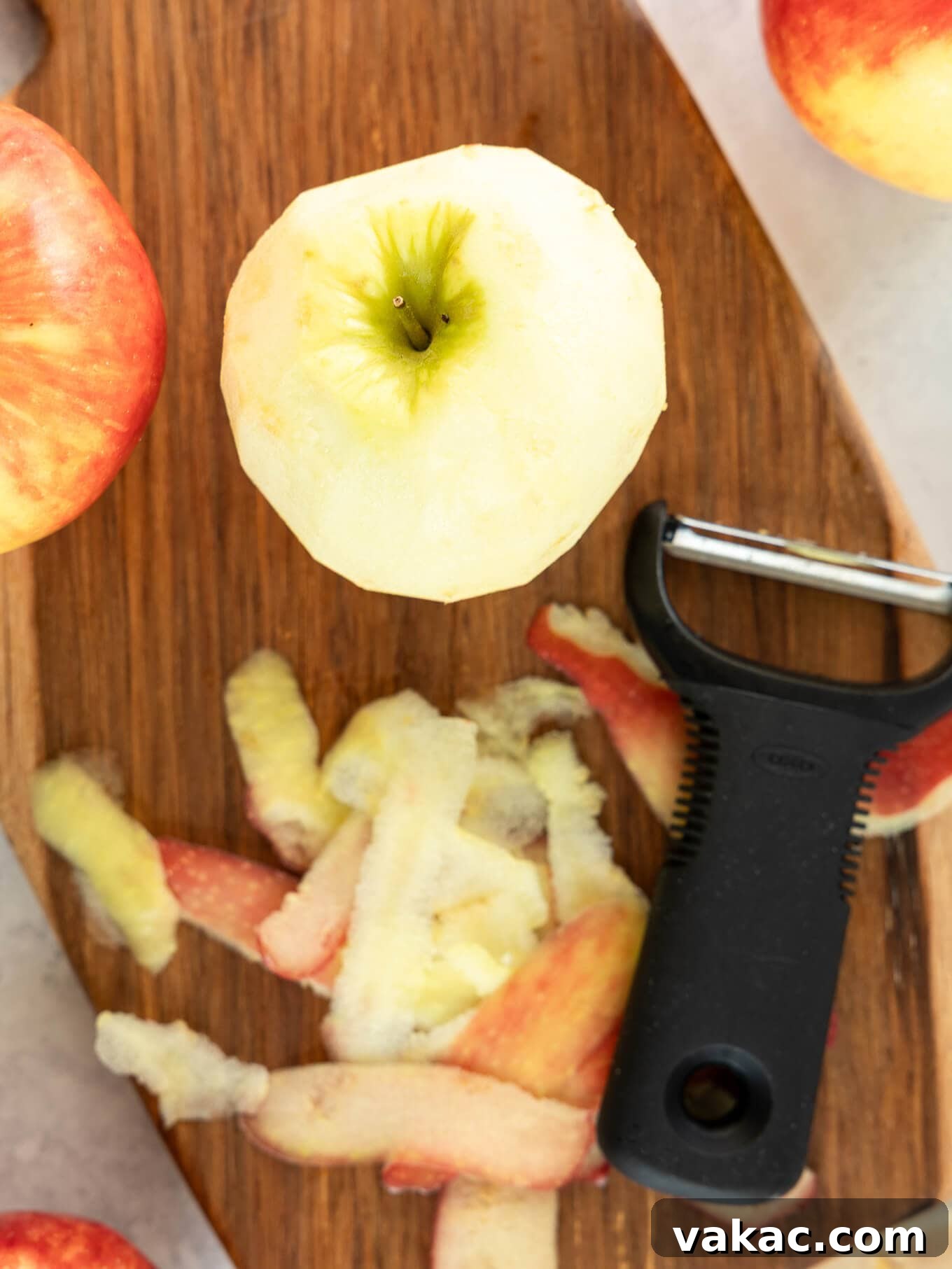 Sweet Skillet Apples 4 An apple being peeled on a cutting board.