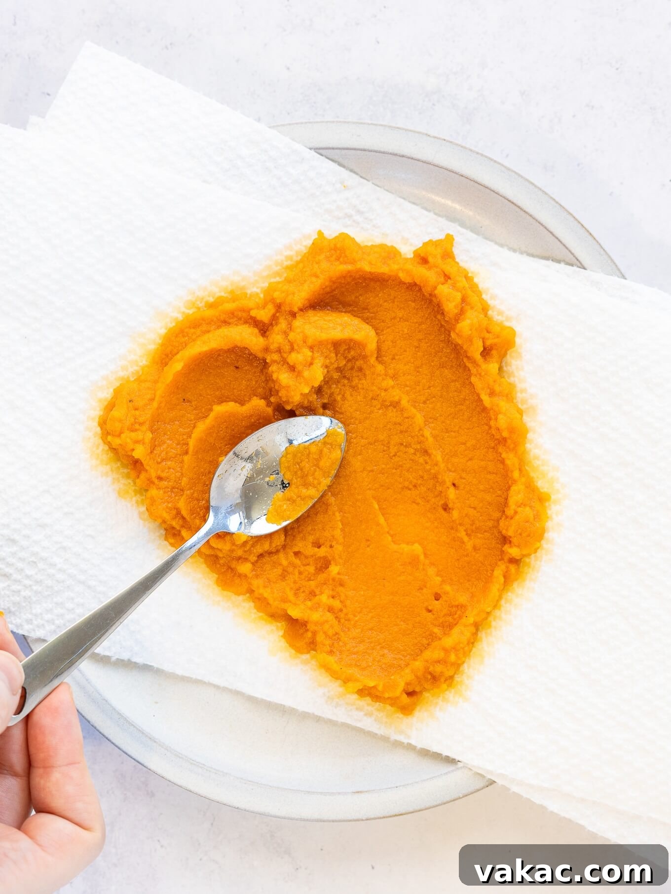 Spiced Pumpkin Fudge 4 An overhead view of pumpkin puree being spread over paper towels.