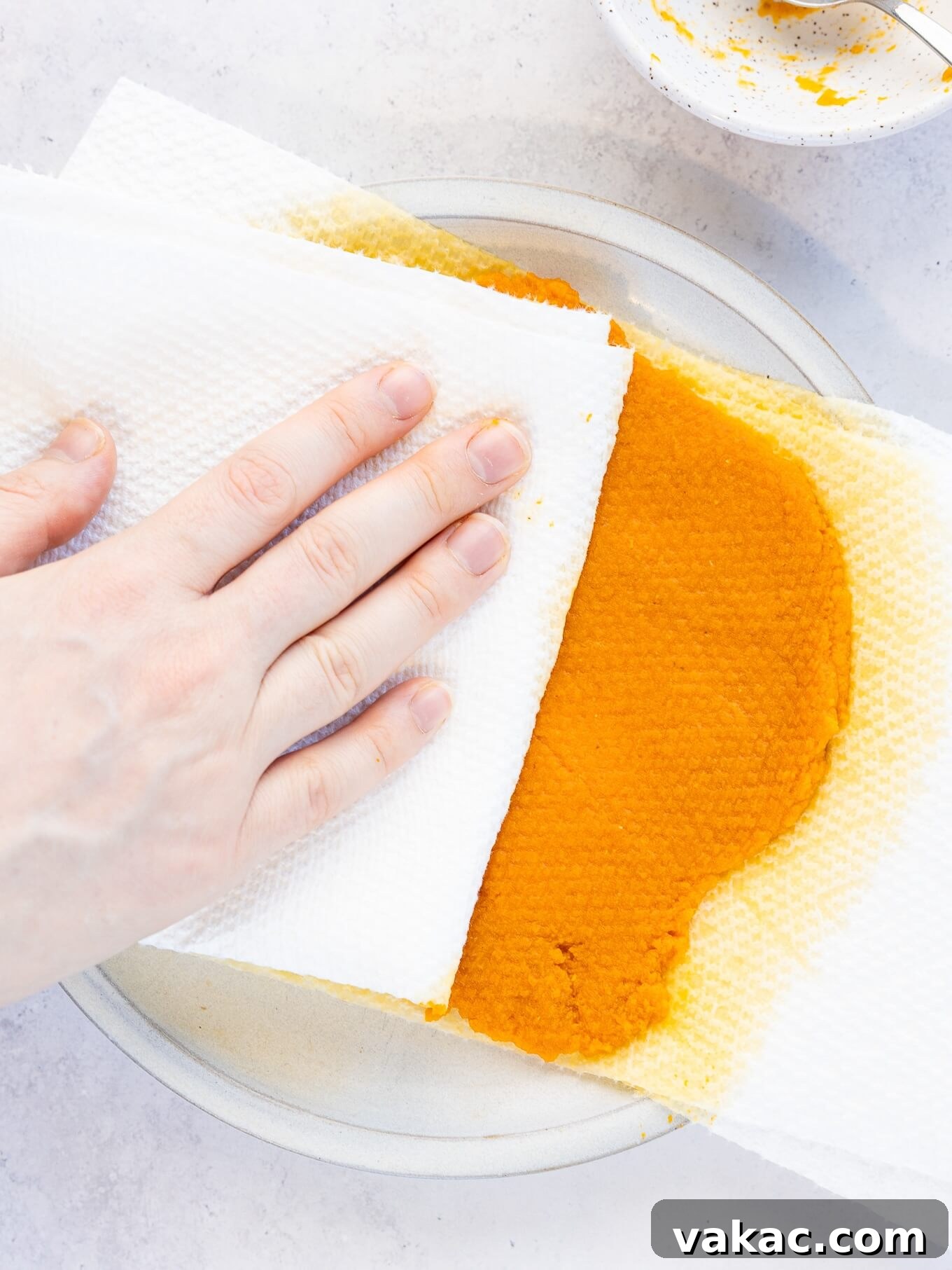 Spiced Pumpkin Fudge 5 An overhead view of pumpkin puree being blotted dry.