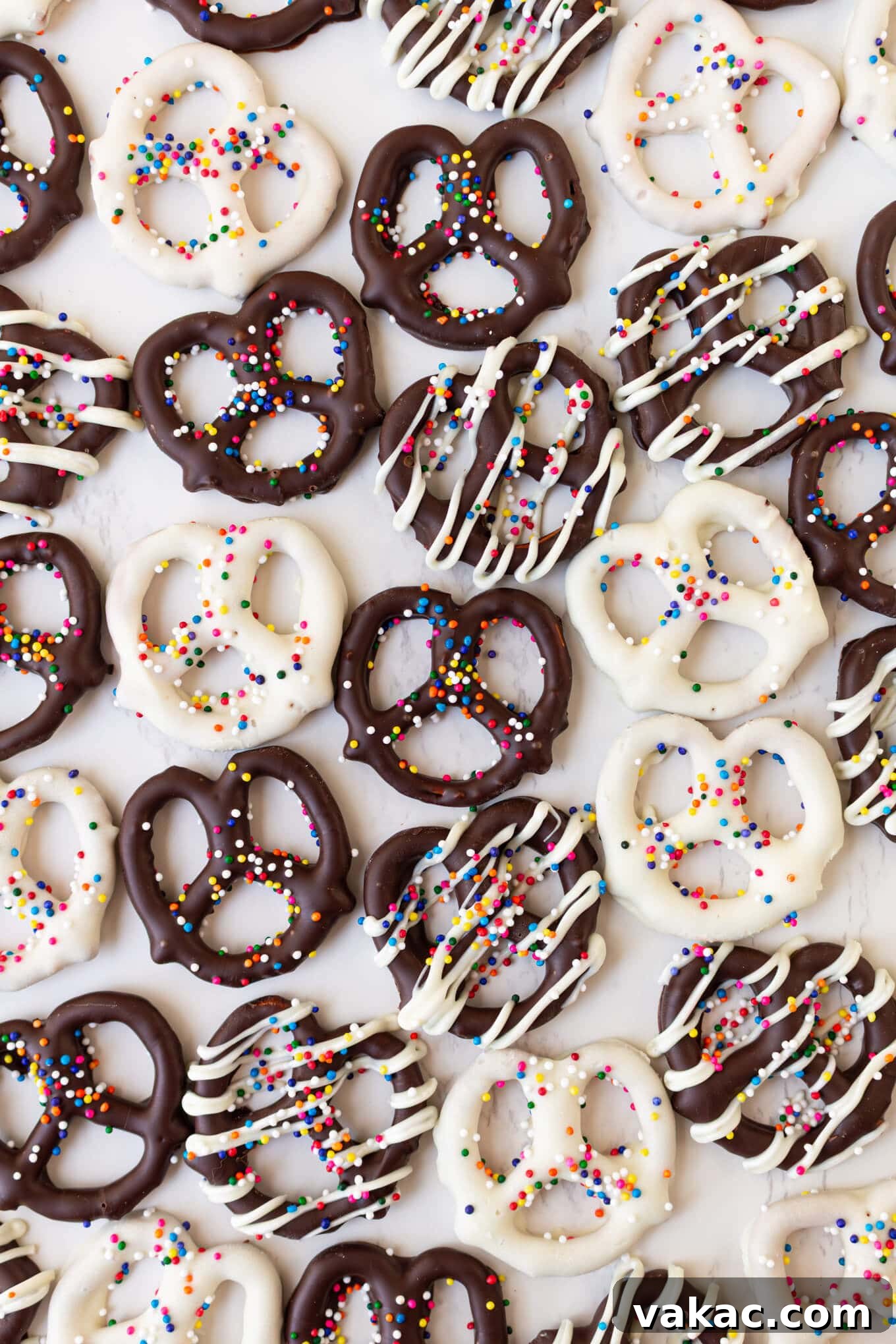 Twisted Chocolate Indulgence 2 White and dark chocolate covered pretzels topped with sprinkles, showcasing a perfect, shiny coating.