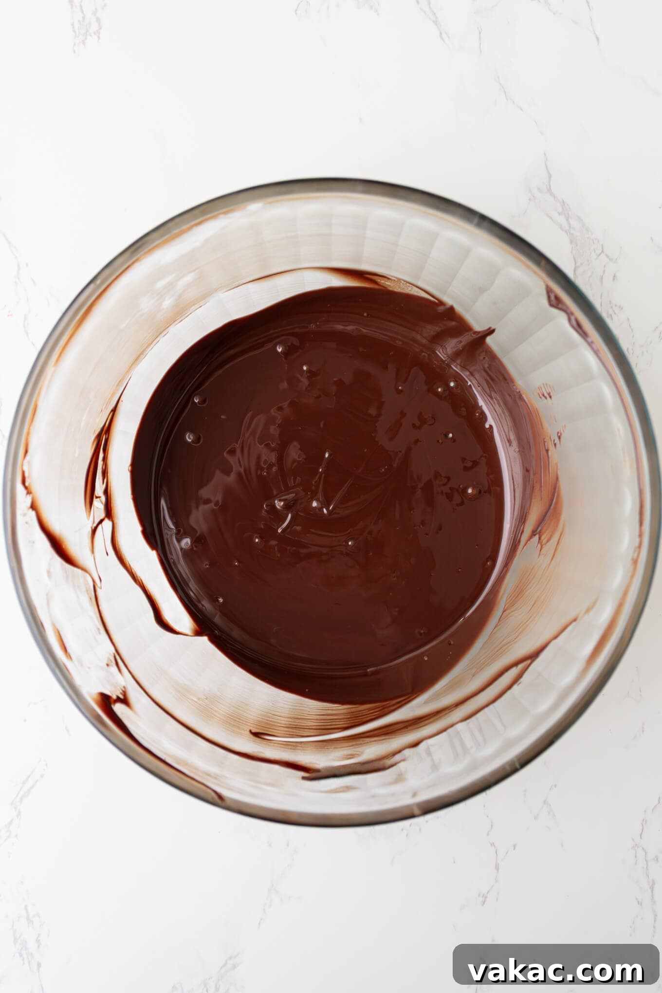 Twisted Chocolate Indulgence 5 Smooth, melted chocolate in a glass bowl, perfectly tempered and ready for dipping.