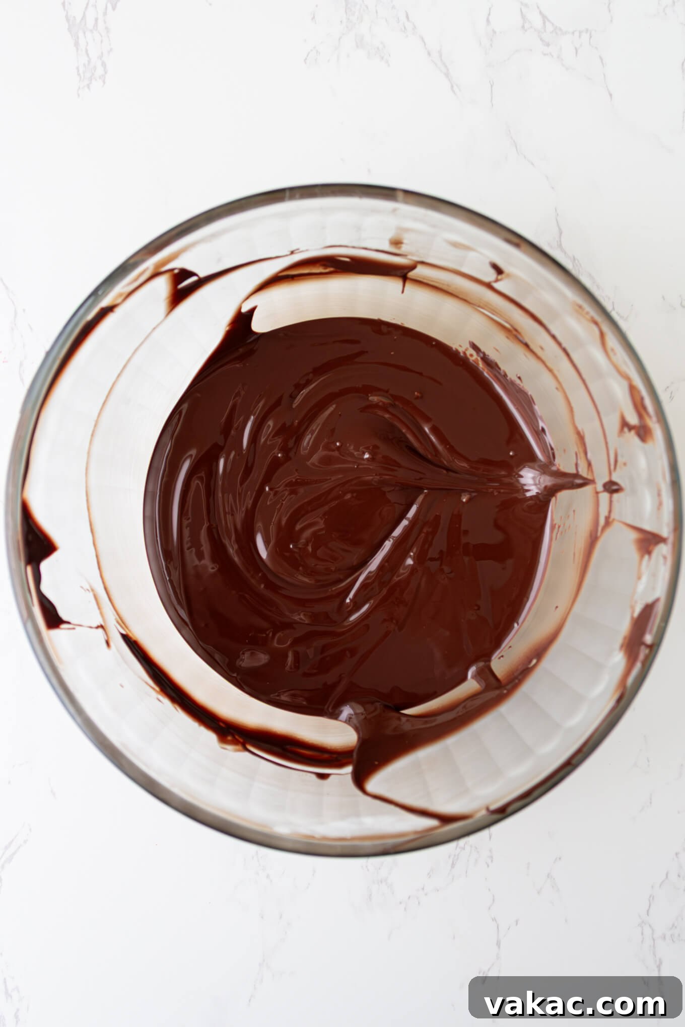 Twisted Chocolate Indulgence 7 Perfectly tempered chocolate, smooth and glossy, ready for dipping in a glass bowl.