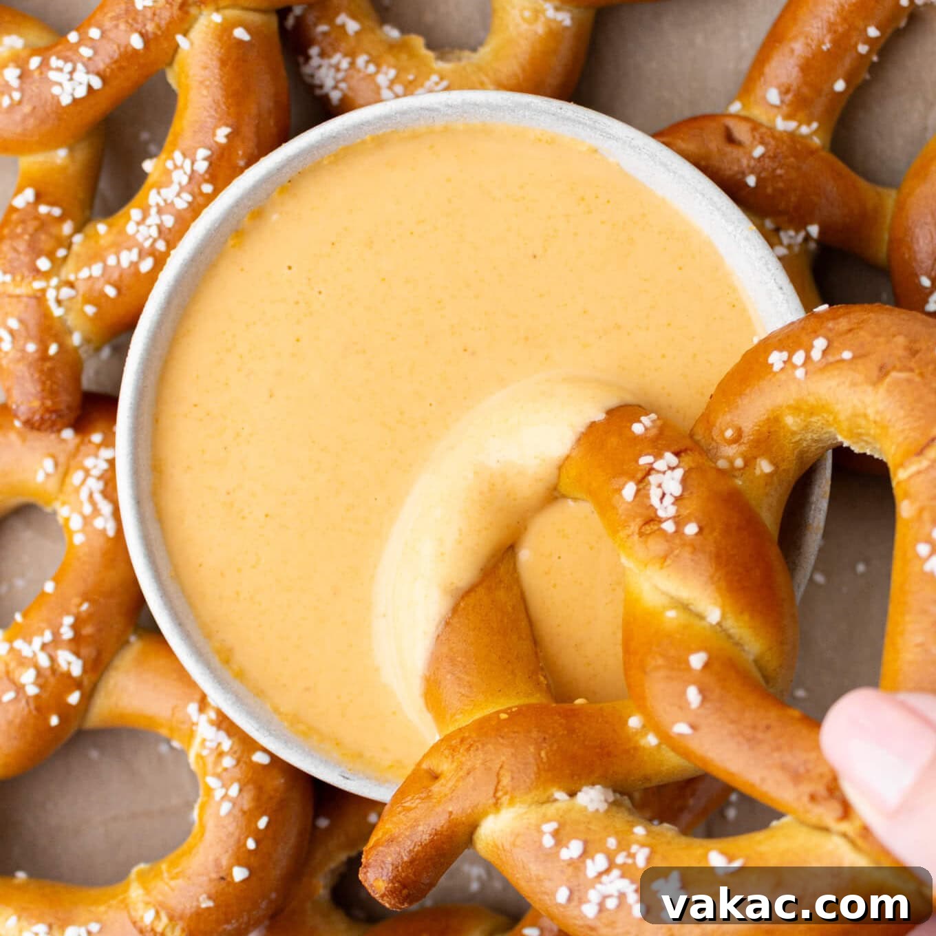 A finished bowl of creamy beer cheese dip, garnished and ready for serving.