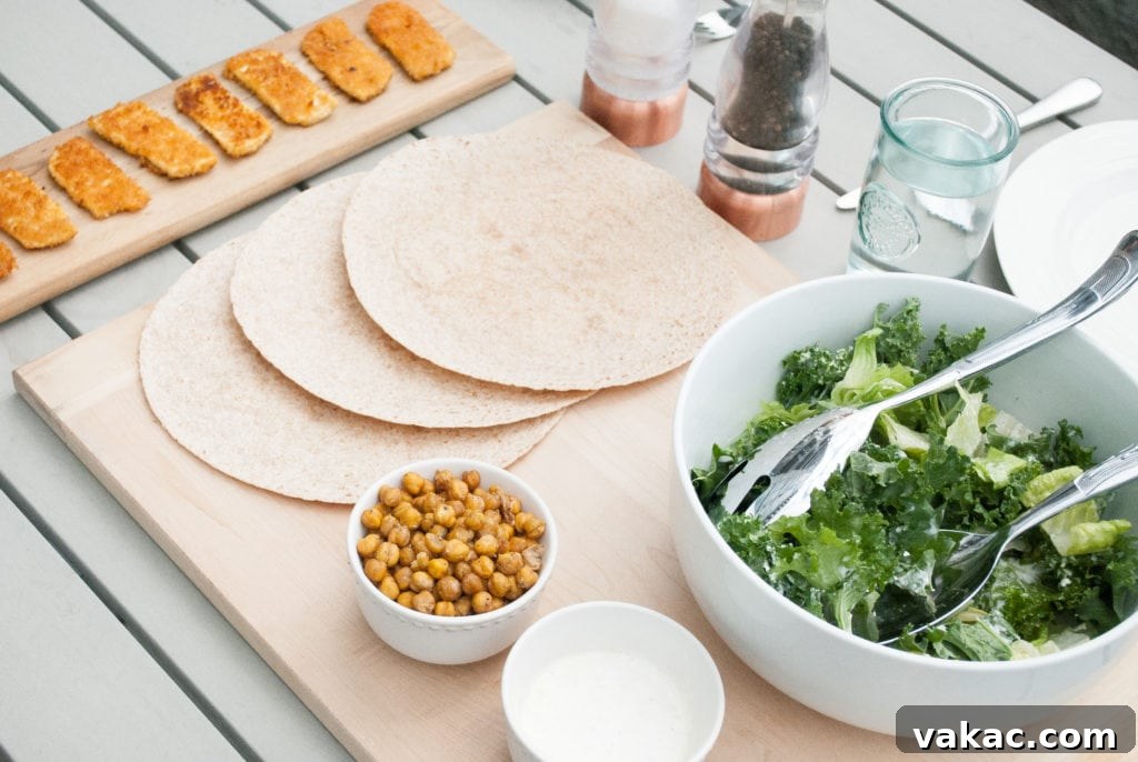 Zesty Buffalo Tofu Caesar Wrap 2 Two halves of a Buffalo Tofu Caesar Wrap on a cutting board