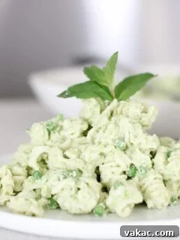 A white round plate on the kitchen counter topped with sourdough pasta. Ingredients include pasta, ricotta, mint leaves, garlic.