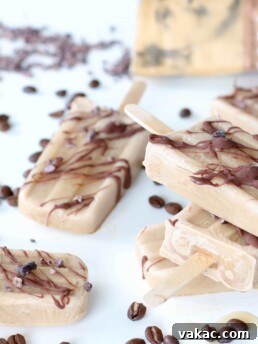 Close-up of Luis Horacio's Coconut Cream Coffee Popsicles with chocolate drizzle