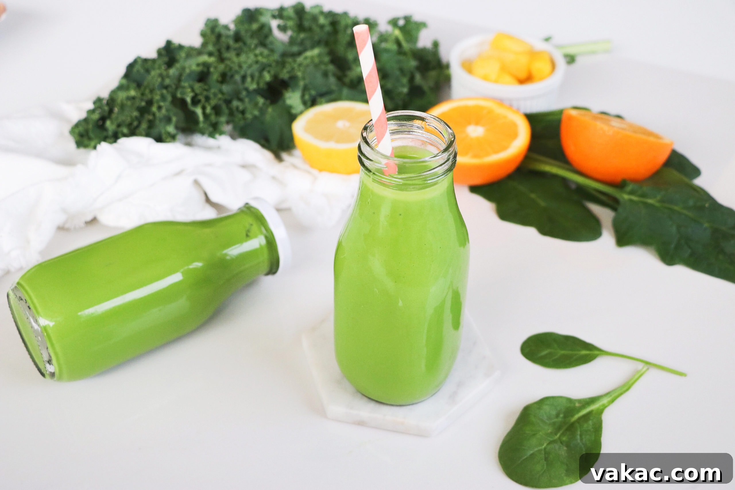 Quick Prenatal Vitality Smoothie 4 Two servings of the pregnancy green smoothie in individual smoothie jars. One jar is sealed, and the other features a charming pink and white striped straw, ready to be enjoyed.
