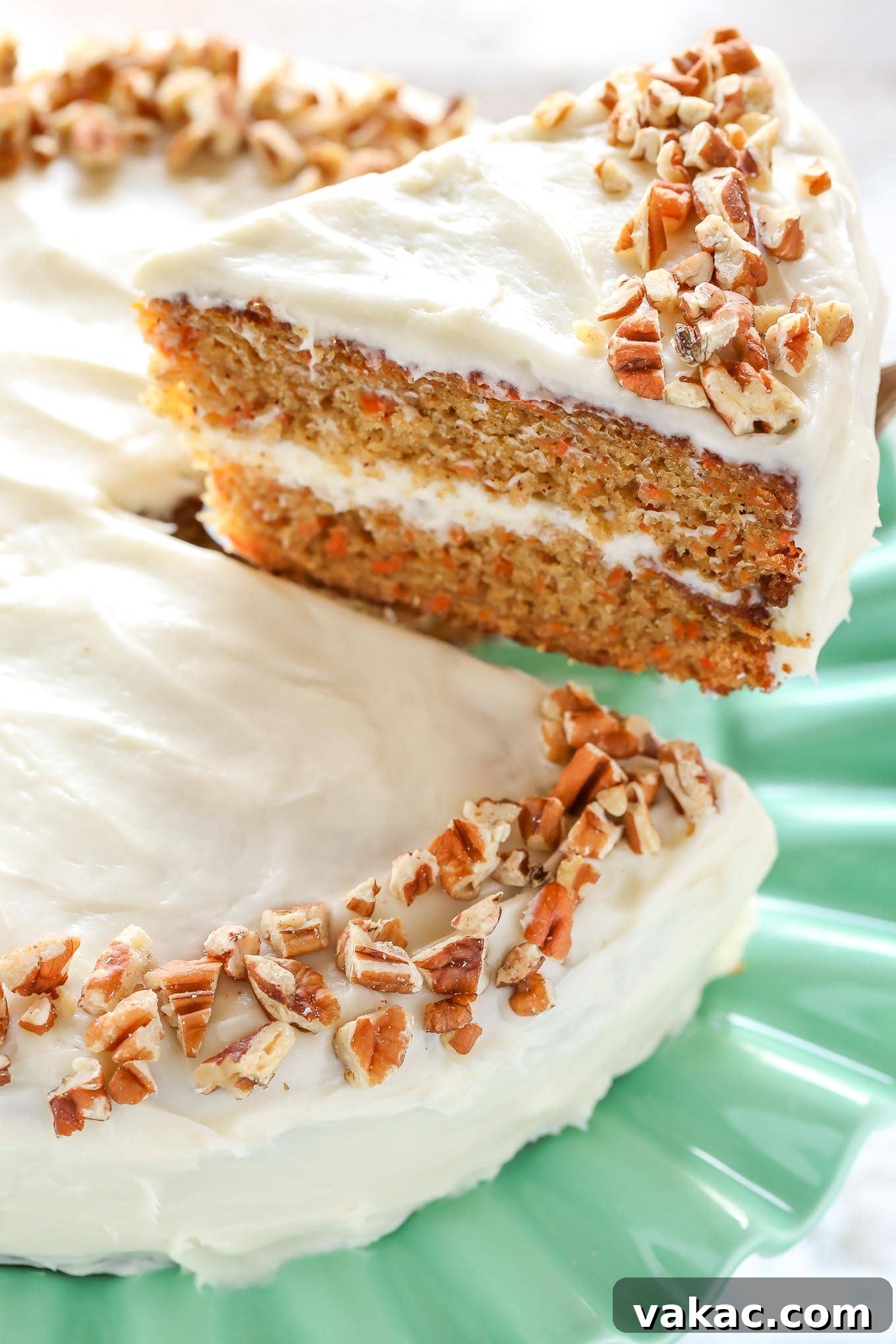 A slice of carrot cake being lifted up to show the texture.