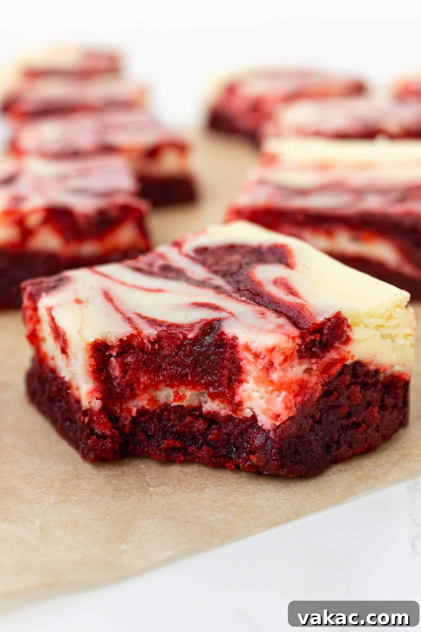 Crimson Cheesecake Brownie Bliss 8 A delectable Red Velvet Cheesecake Brownie with a bite taken, revealing its rich, moist interior and beautifully marbled layers.